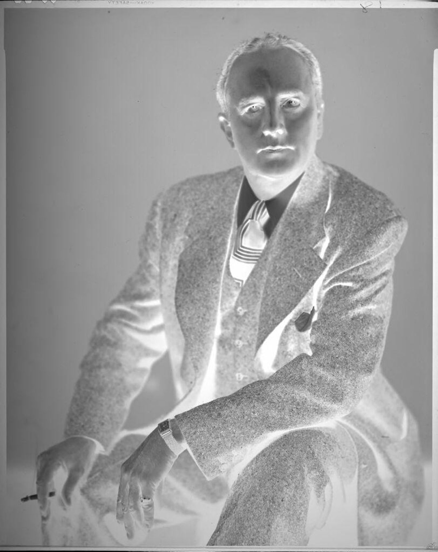 Untitled (portrait of man wearing suit holding cigarette) by John Howell