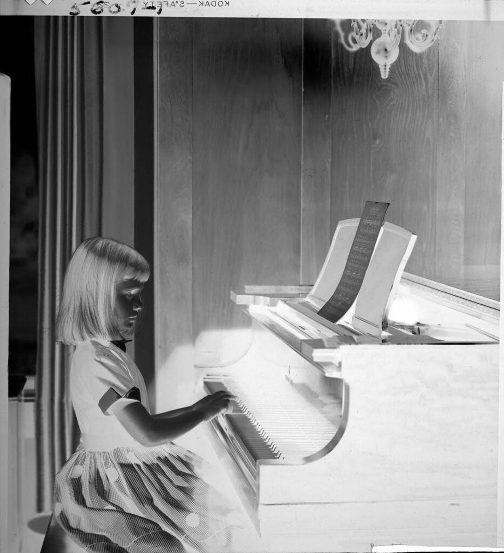 Untitled (little girl playing piano) by John Howell