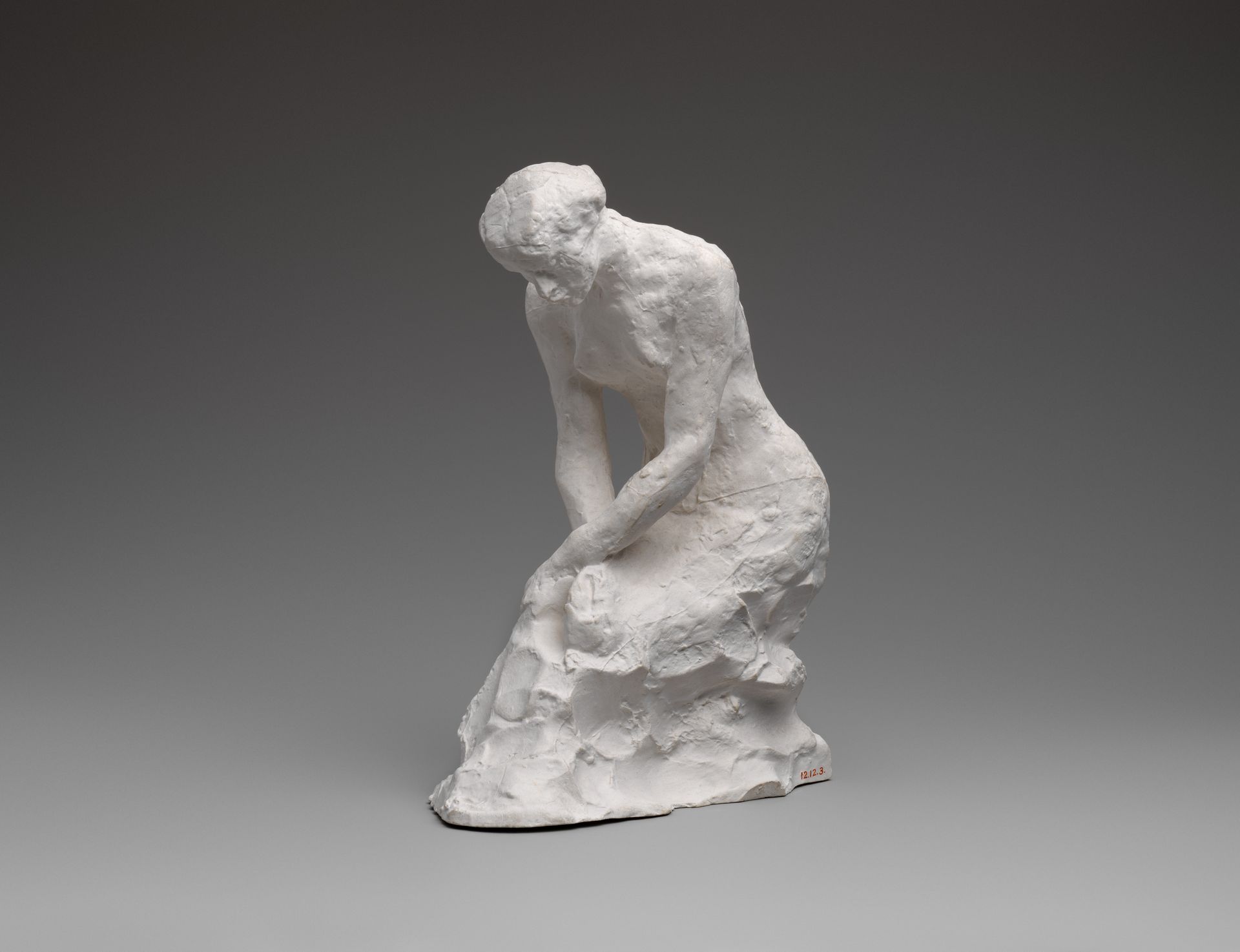 Young woman kneeling by Auguste Rodin
