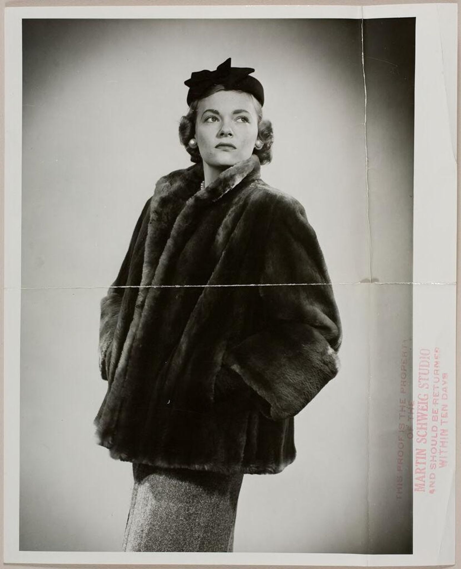 Untitled (fashion portrait of woman wearing fur coat and large pearl earrings) by Martin Schweig