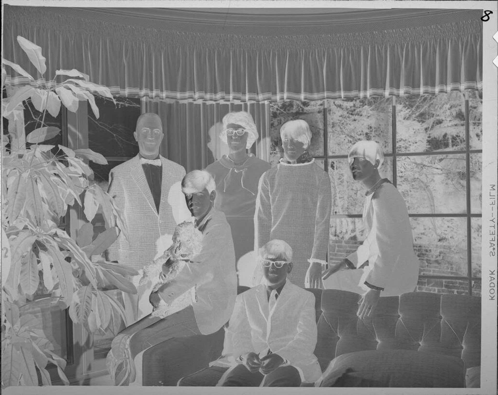 Untitled (family portrait on couch in front of window) by Lucian and Mary Brown