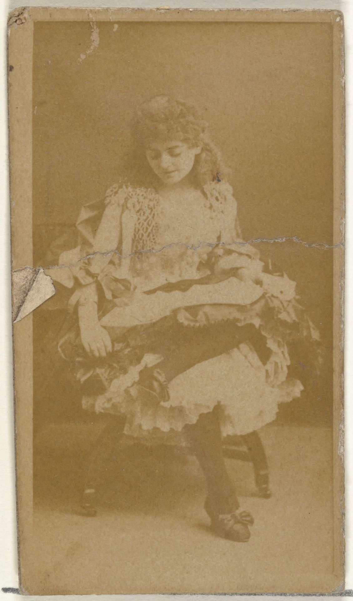 [Seated actress, looking down], from the Actors and Actresses series (N145-8) issued by Duke Sons & Co. to promote Duke Cigarettes by W. Duke, Sons & Co.