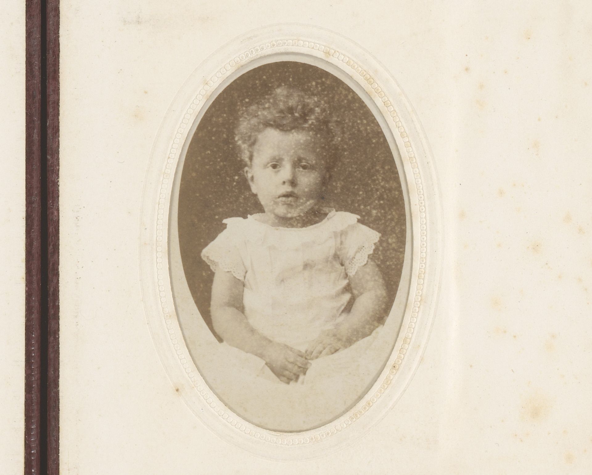 Portret van een kind in witte jurk by Hisgen Brothers