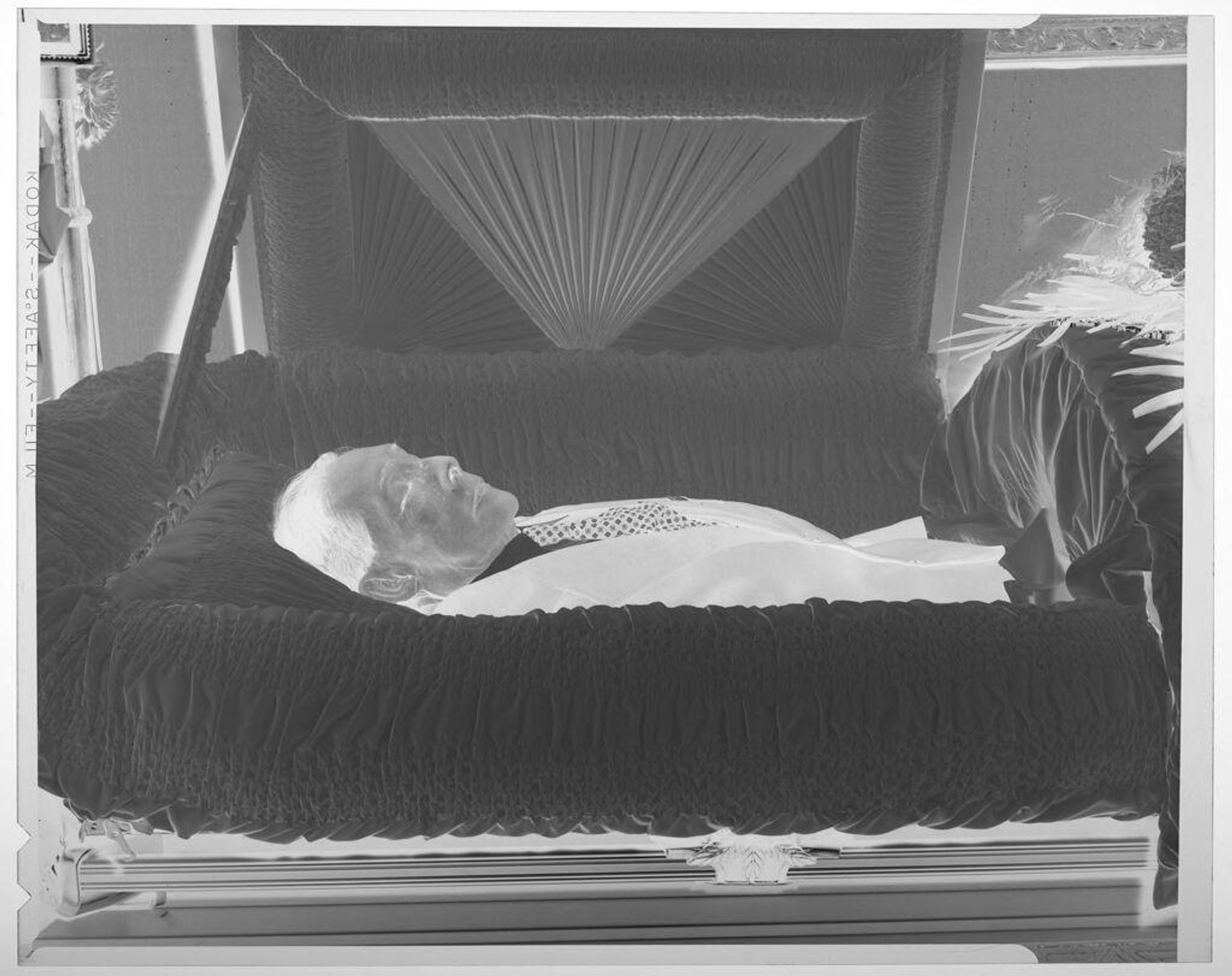 Untitled (deceased man in coffin in funeral home, close up) by Harry Annas