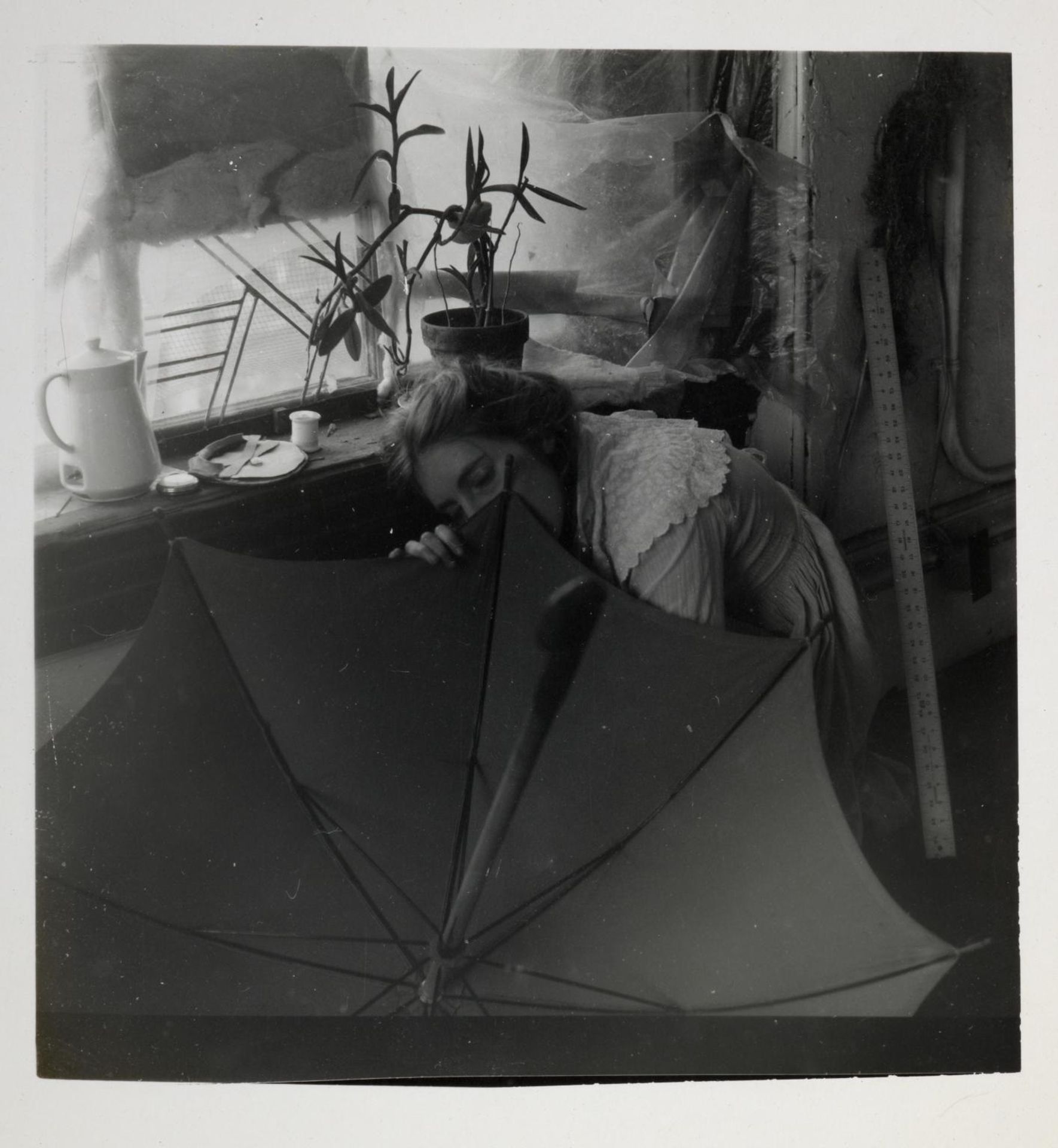 Untitled (FW crouching behind umbrella) by Francesca Woodman