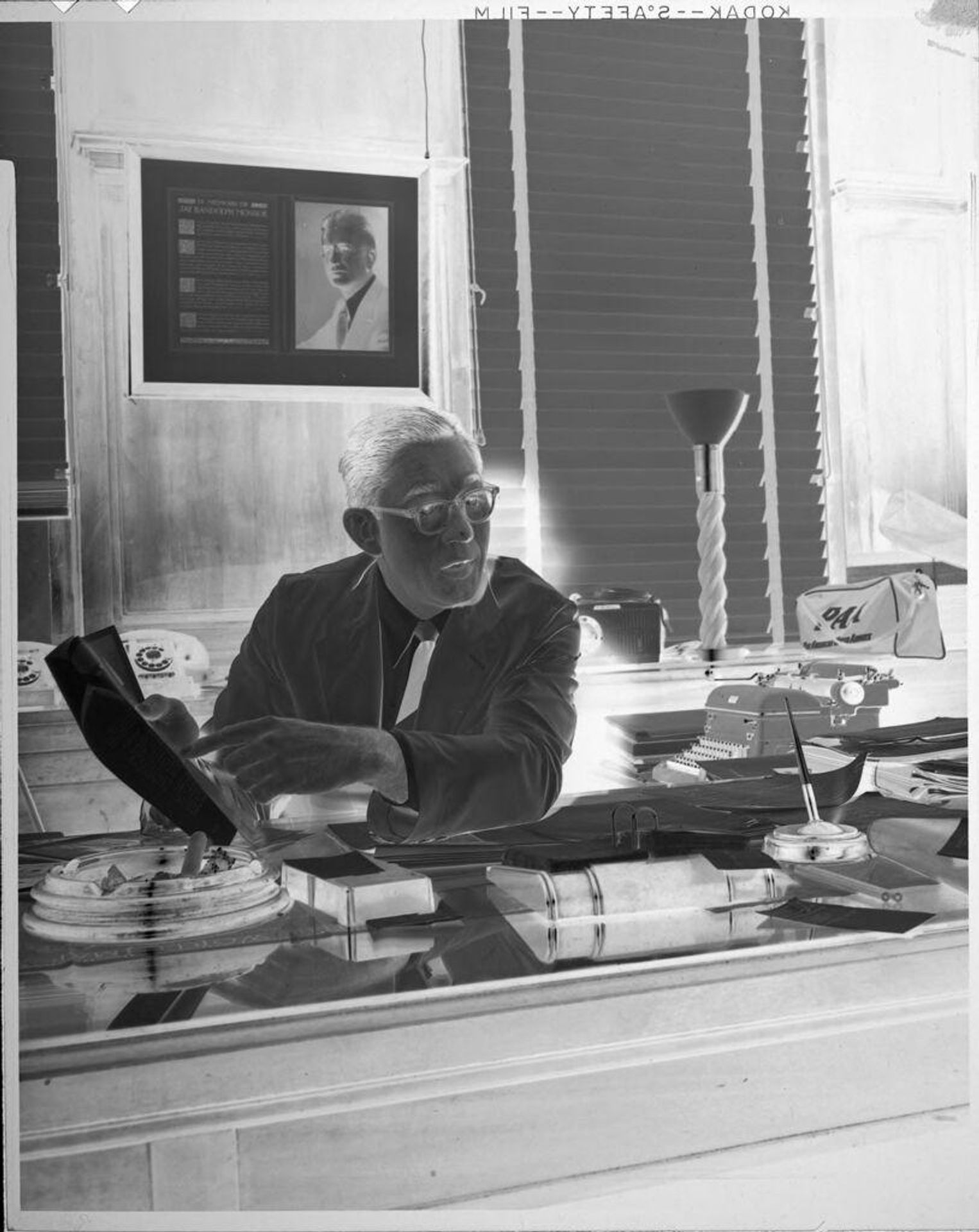 Untitled (man behind desk) by Peter James Studio