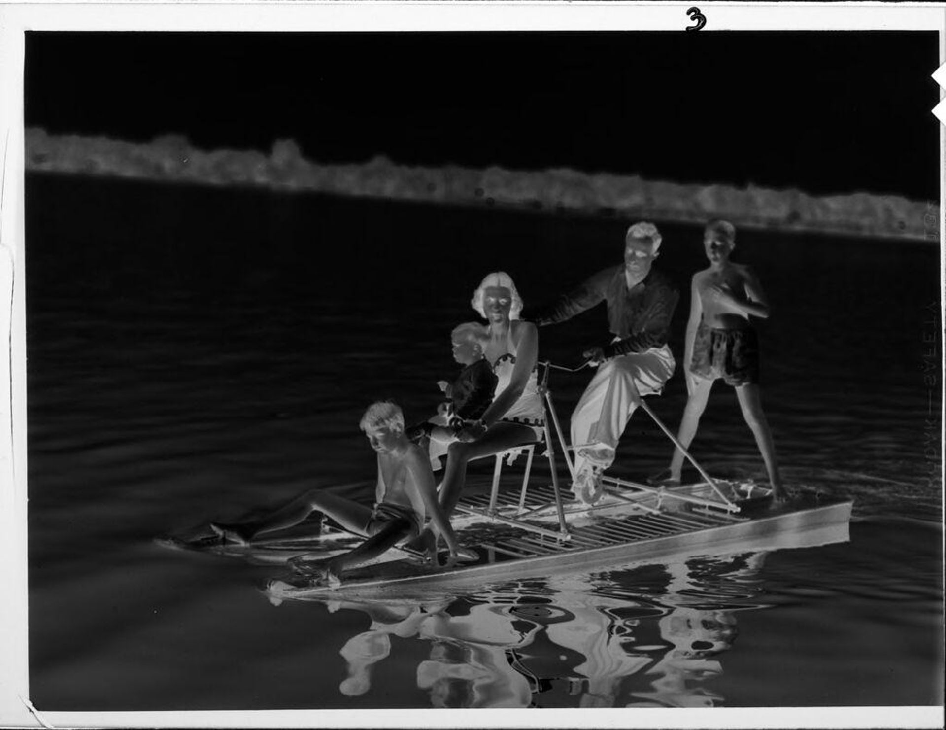 Untitled (family on bicycle-powered raft on lake) by Lucian and Mary Brown