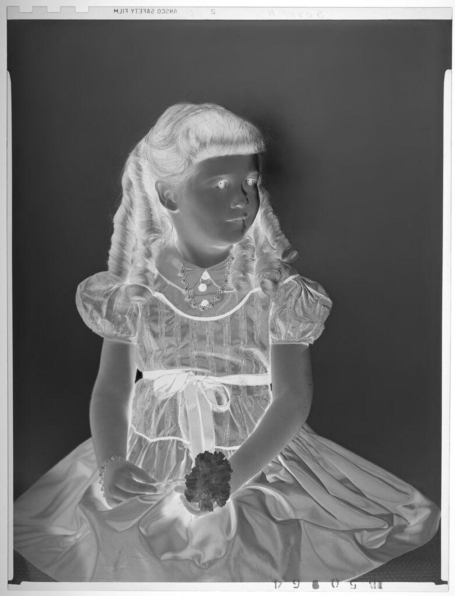 Untitled (portrait of girl with ringlets in dress, seated, holding carnation) by Paul Gittings