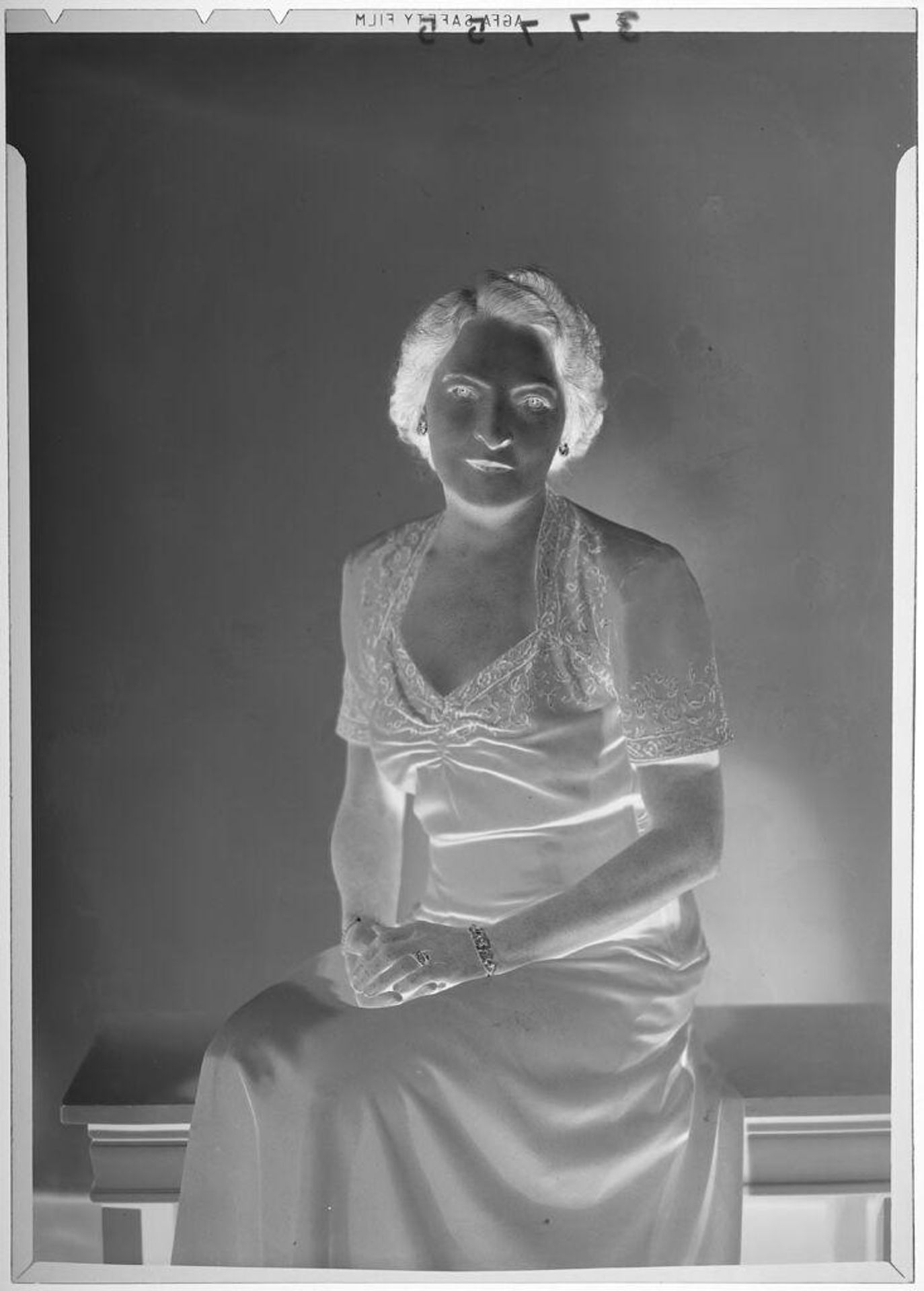 Untitled (studio portrait of middle-aged woman in v-neck dress) by Martin Schweig