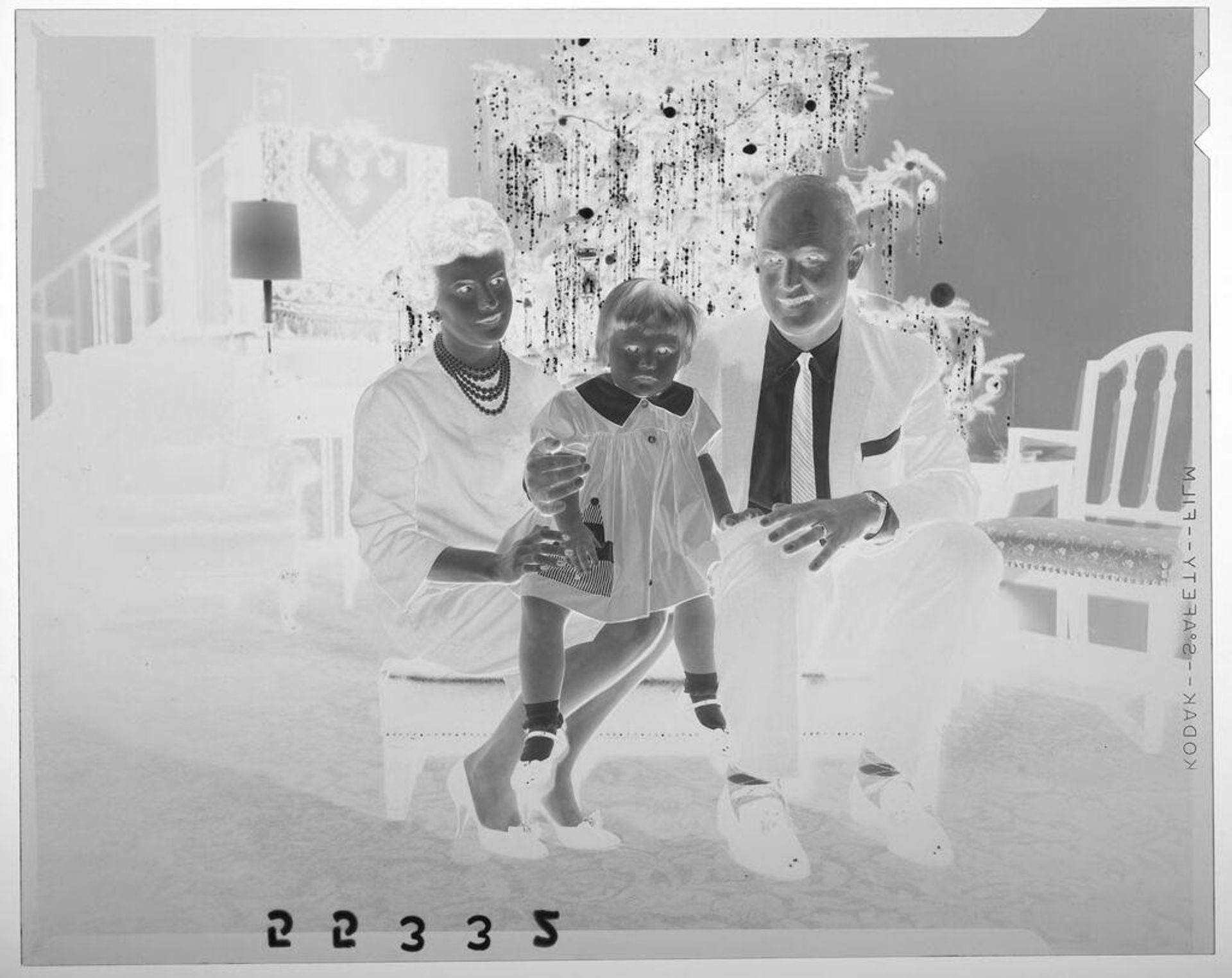 Untitled (couple and young daughter posed sitting in front of Christmas tree) by Martin Schweig