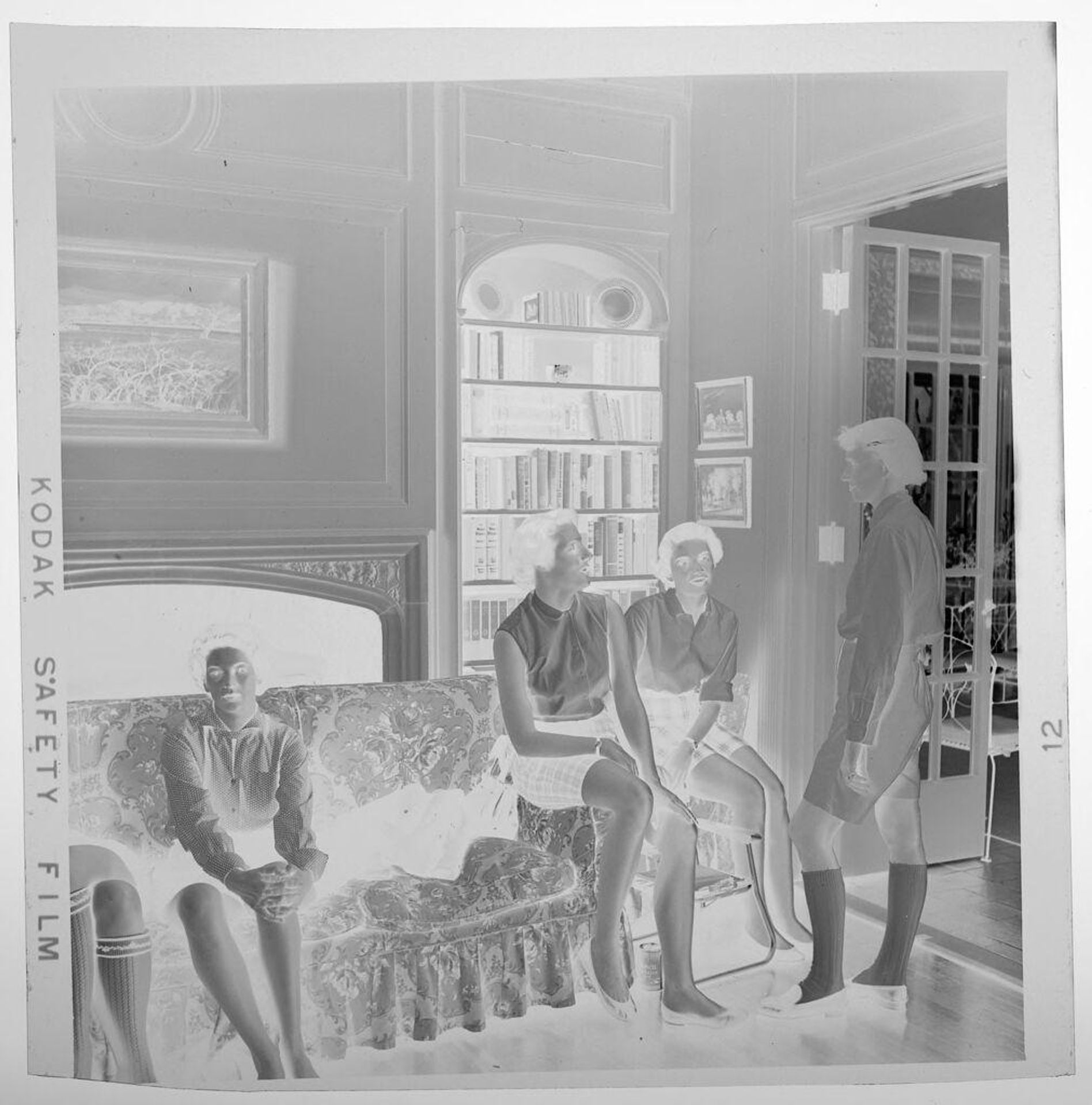 Untitled (women in living room, three on couch and one standing) by Jack Gould