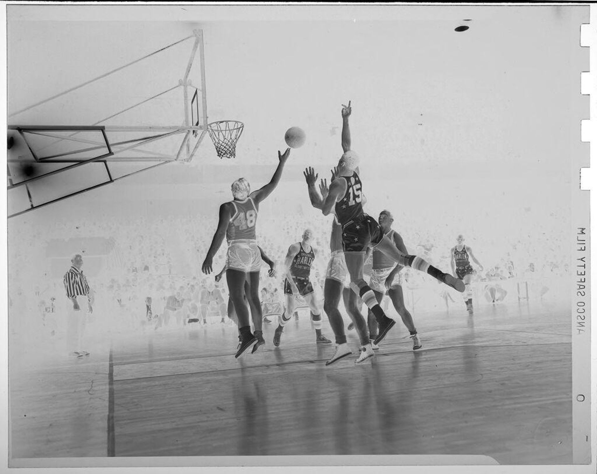 Untitled (basketball players playing on court; shooting a basket, Harlem Globe Trotters) by Jack Gould