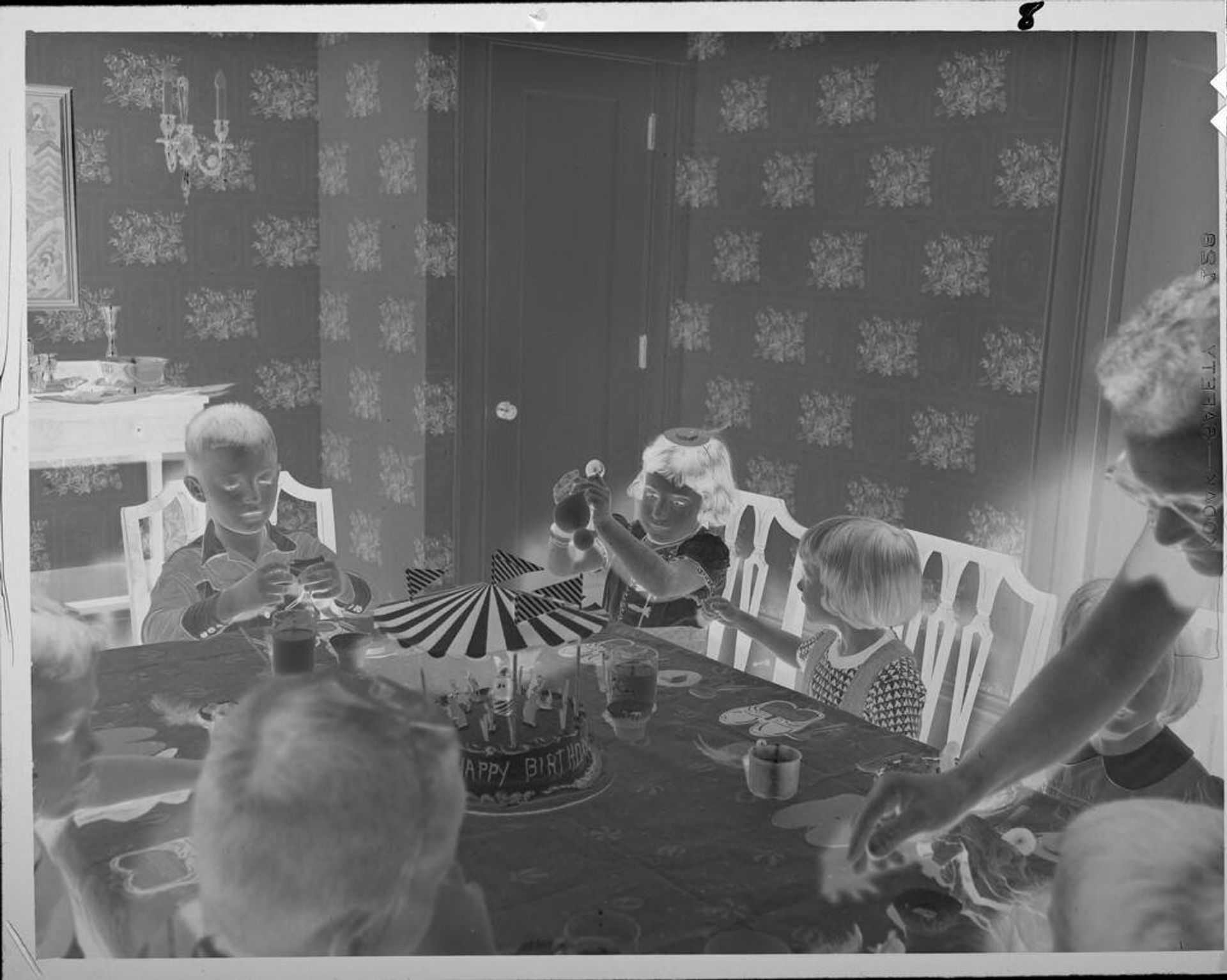 Untitled (children at table with birthday cake) by Lucian and Mary Brown
