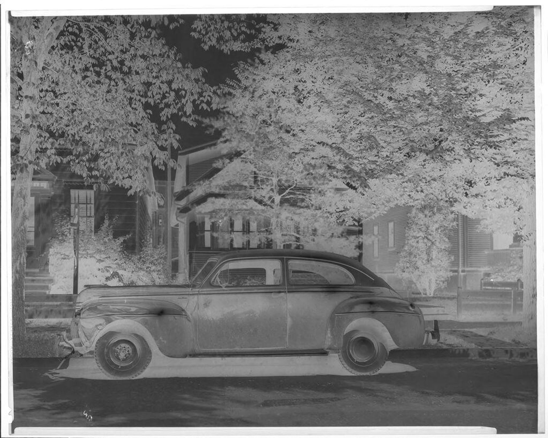 Untitled (car in front of house) by John Deusing
