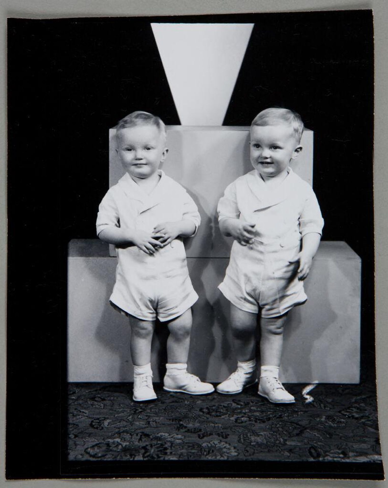 Untitled (studio portrait of two toddler boys standing in front of two blocks) by Martin Schweig