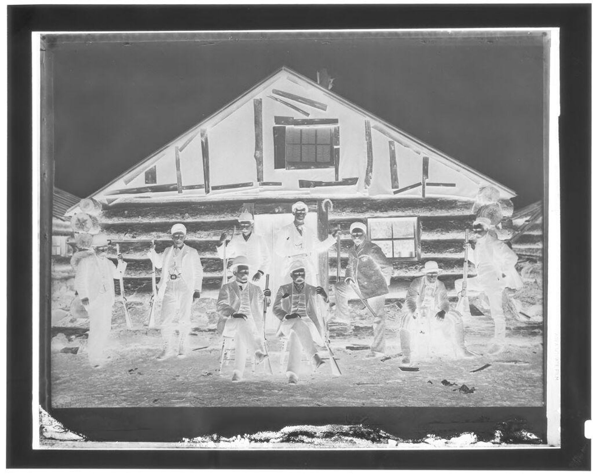 Untitled (men with shot guns outside cabin) by John Deusing
