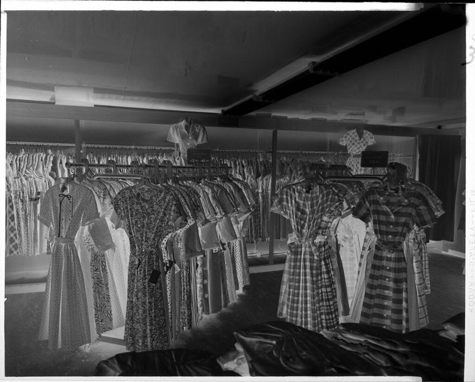 Untitled (dresses on racks) by Ken Whitmire Associates