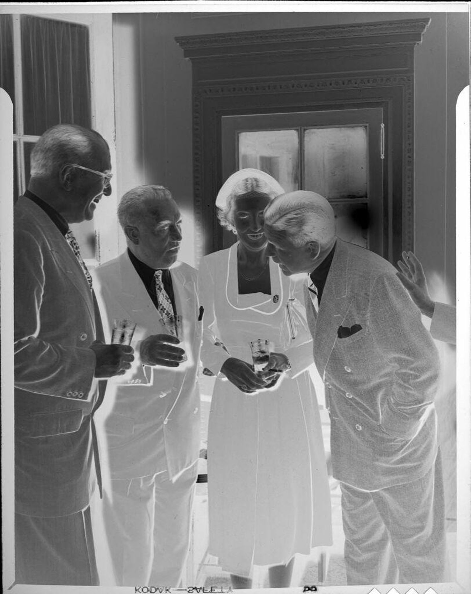 Untitled (three men and woman at party) by Peter James Studio
