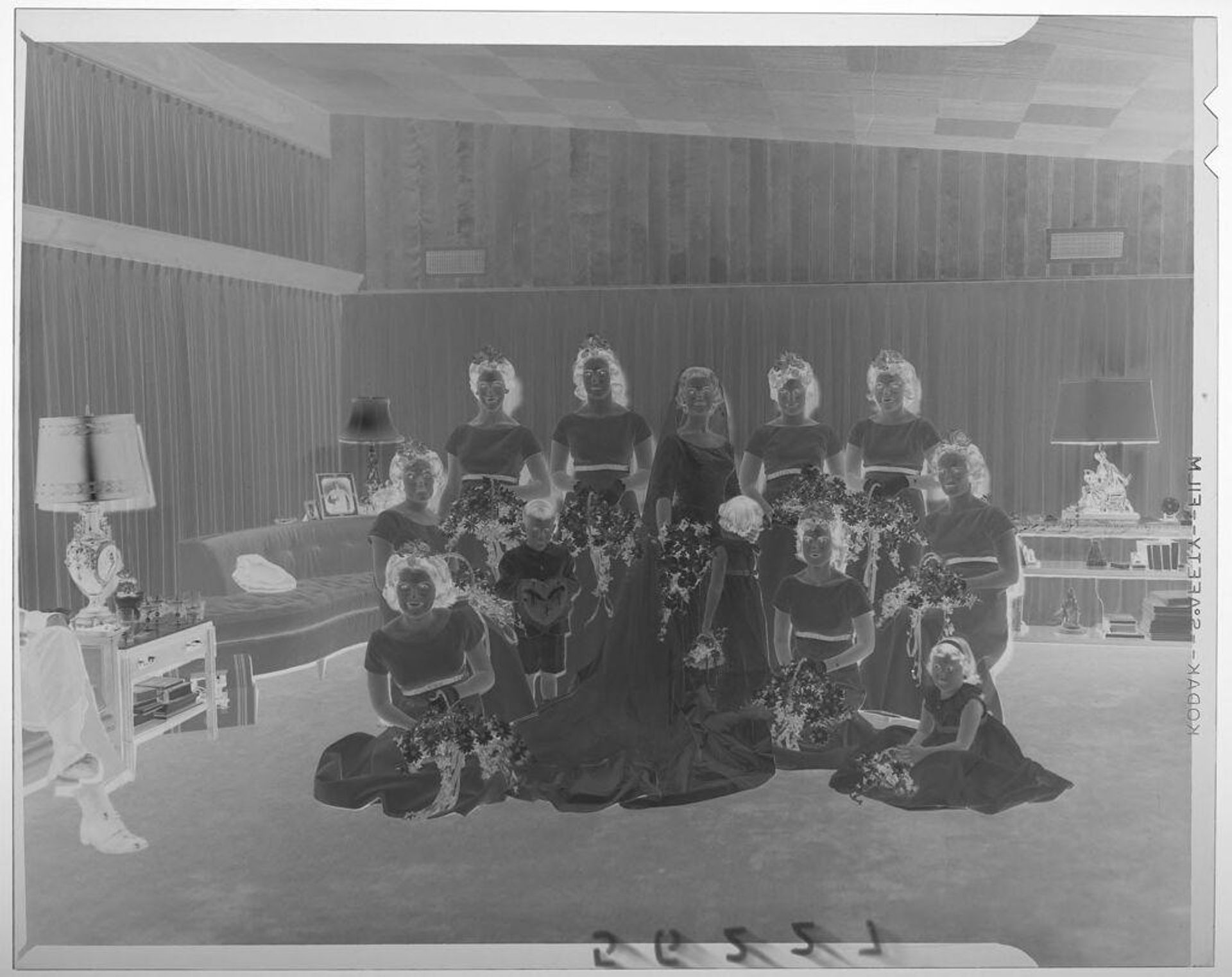 Untitled (bride and large wedding party posing in large room with couches and table) by Martin Schweig