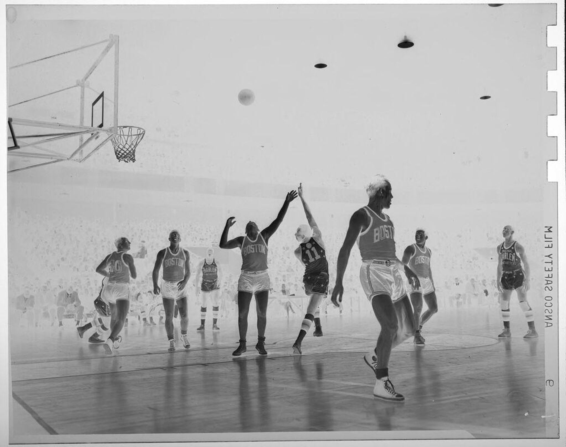 Untitled (basketball players playing on court; shooting a basket, Harlem Globe Trotters) by Jack Gould