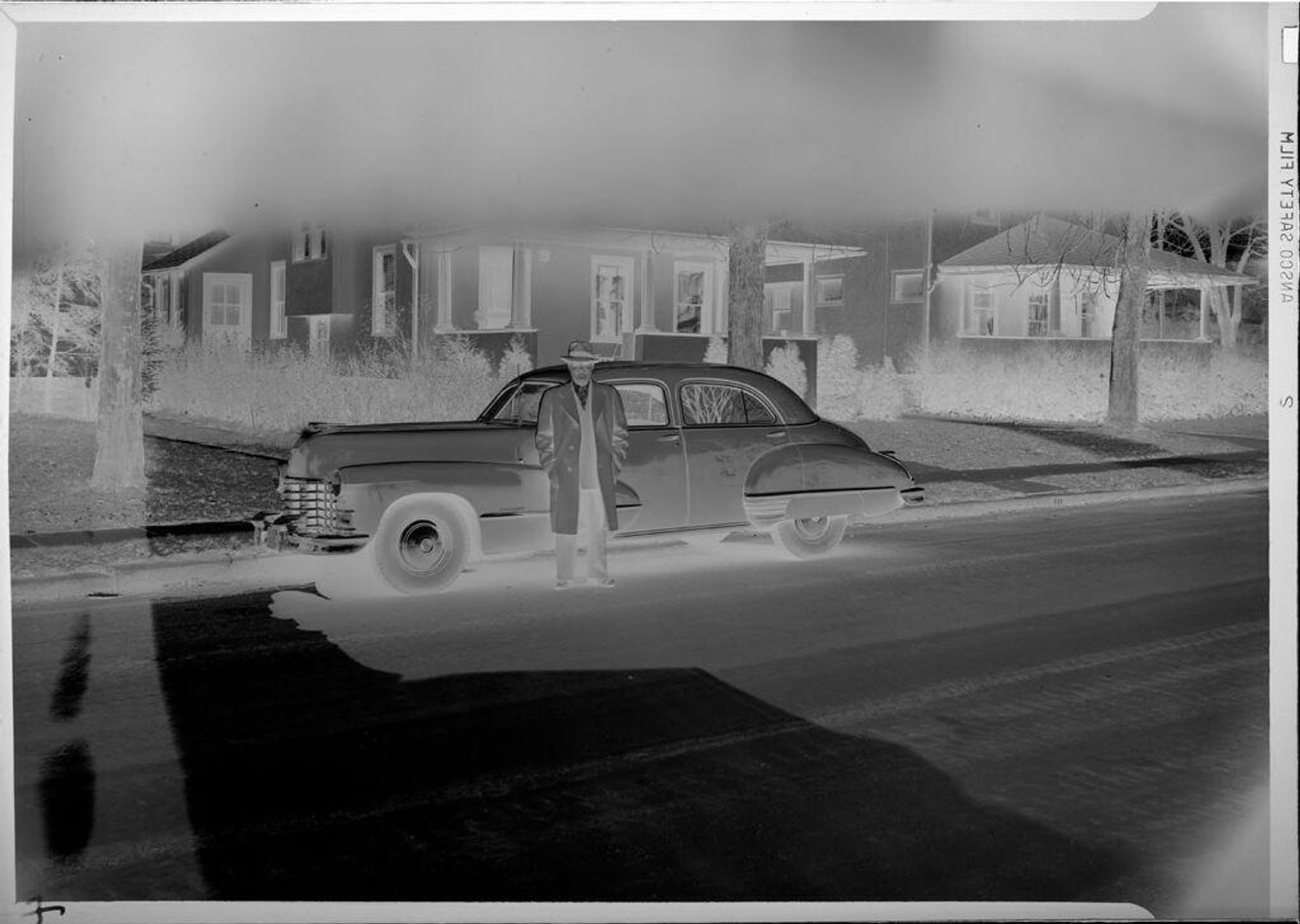 Untitled (man standing by car) by Robert Burian