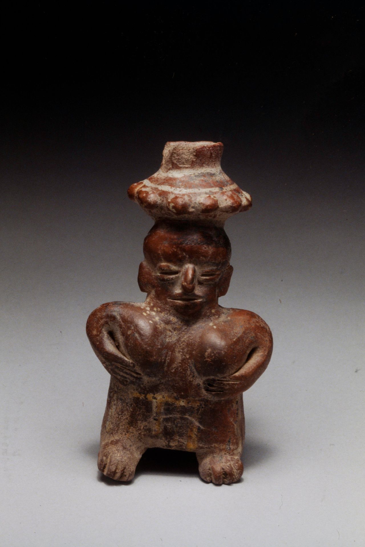 Standing female figure with bowl on head by Nayarit