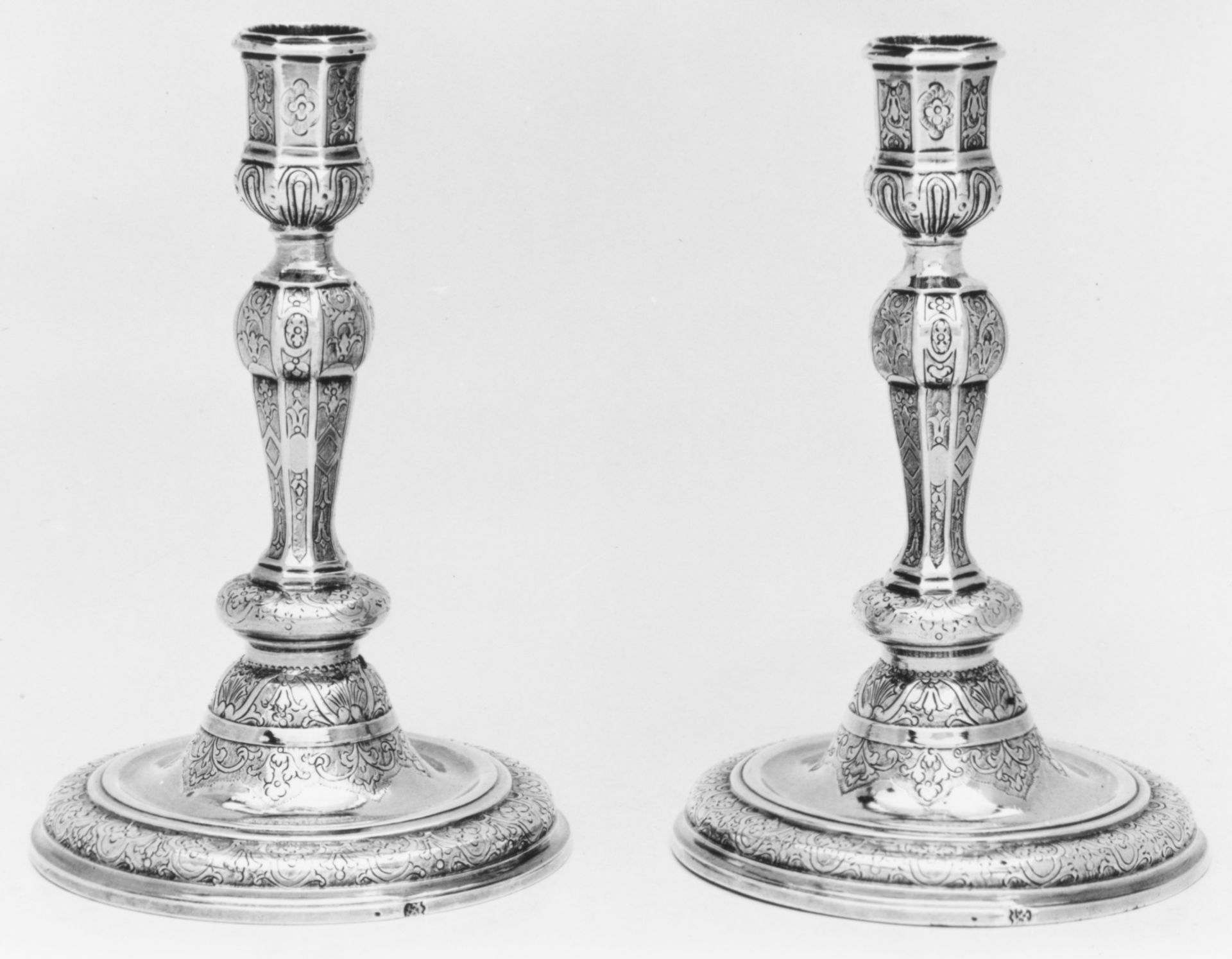 Pair of candlesticks by N.H. (?)