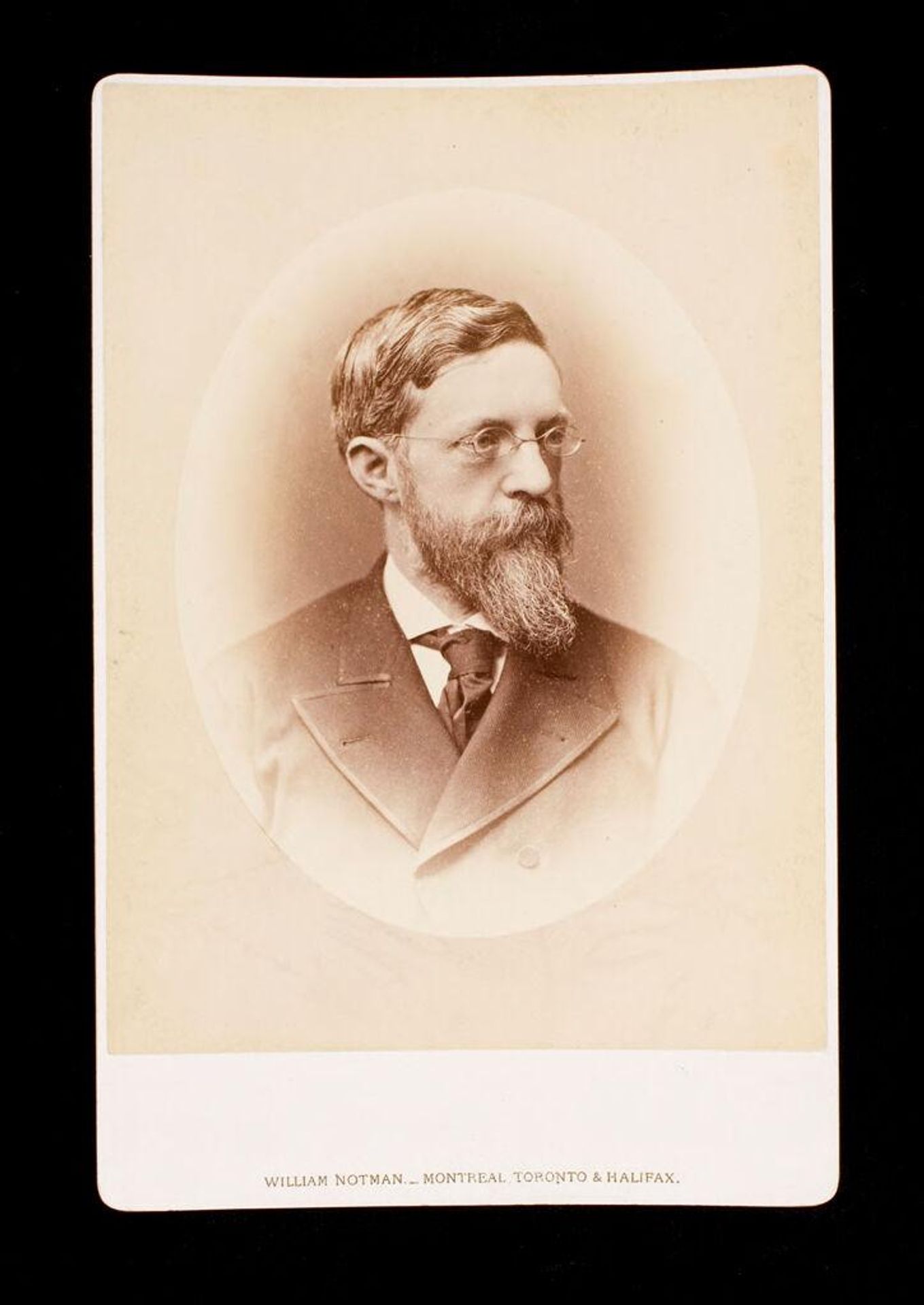 Untitled (bust length portrait of man with beard, wearing glasses, labeled Hill) by William Notman