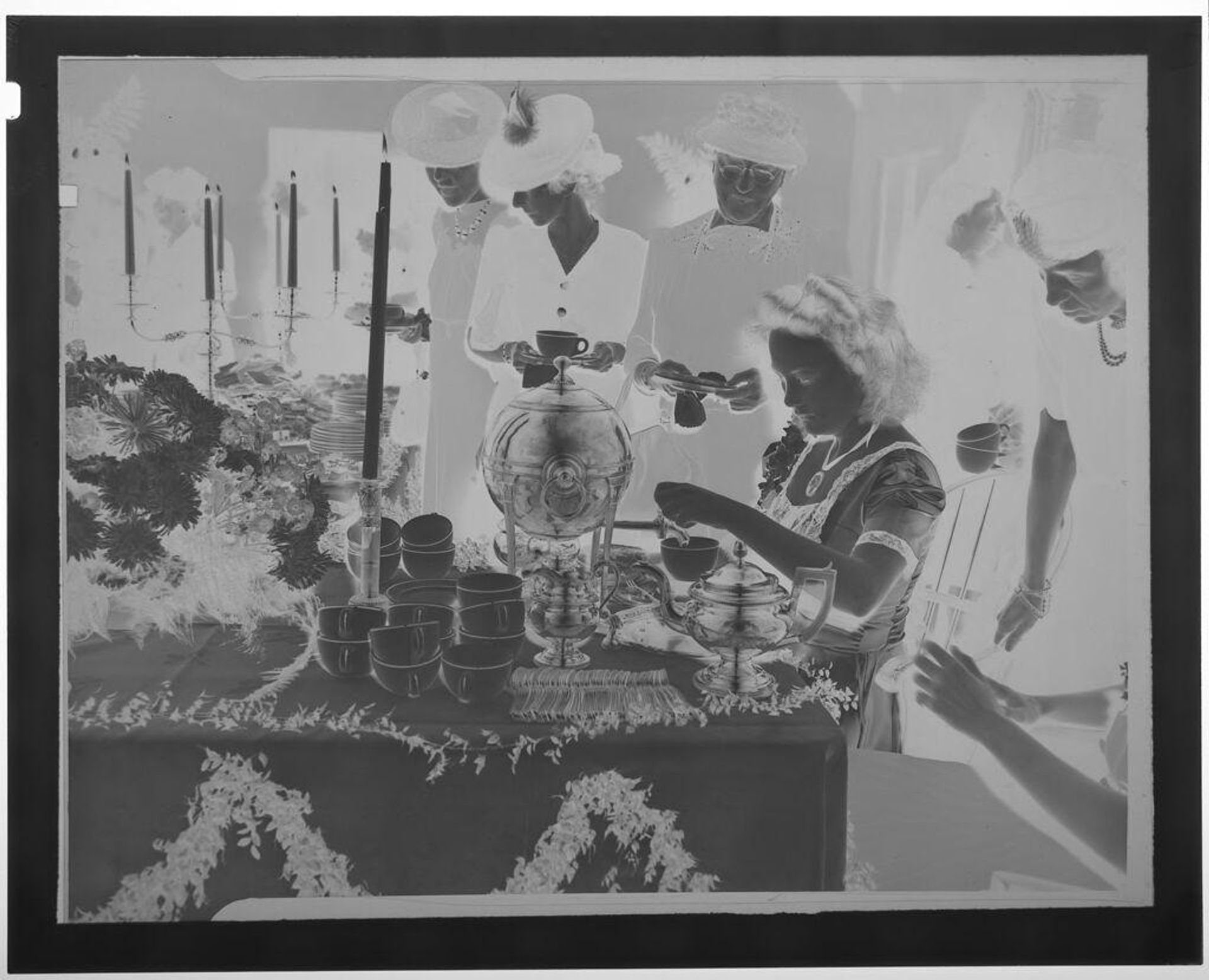 Untitled (young girl pouring tea at buffet table surrounded by women) by Martin Schweig
