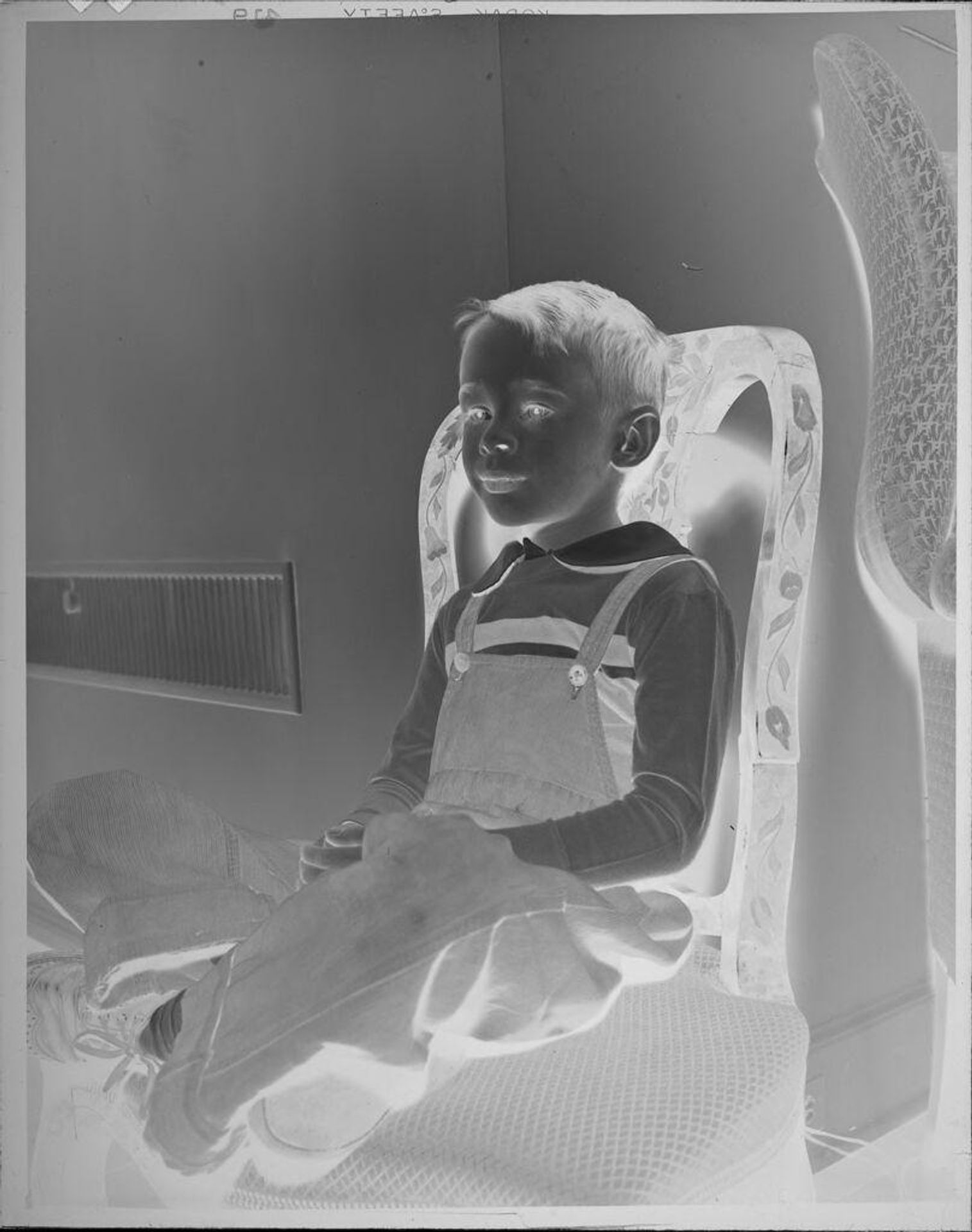Untitled (portrait of boy on chair) by Lucian and Mary Brown