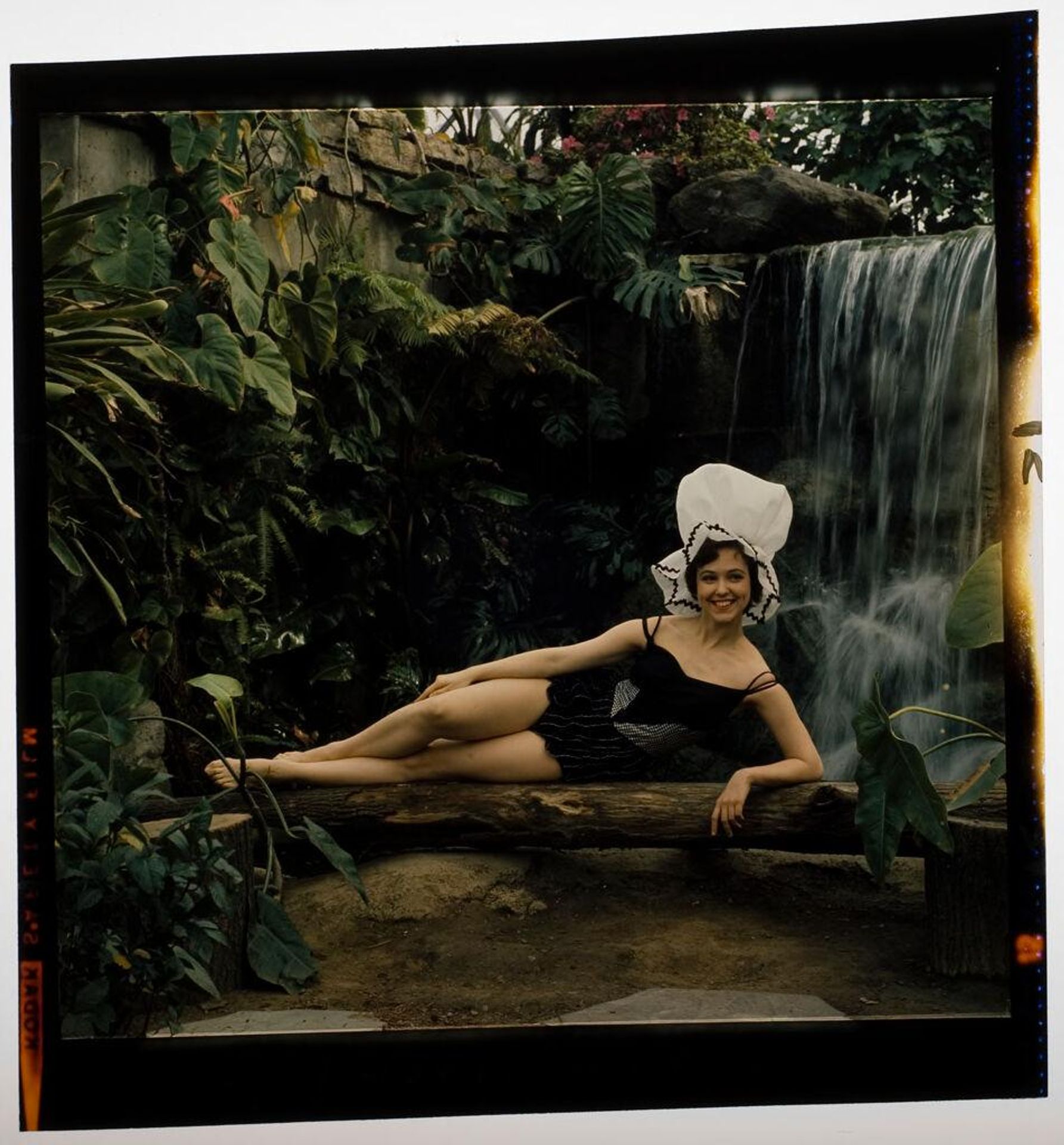 Untitled (woman modeling swim wear and large hat in indoor rainforest) by Jack Gould