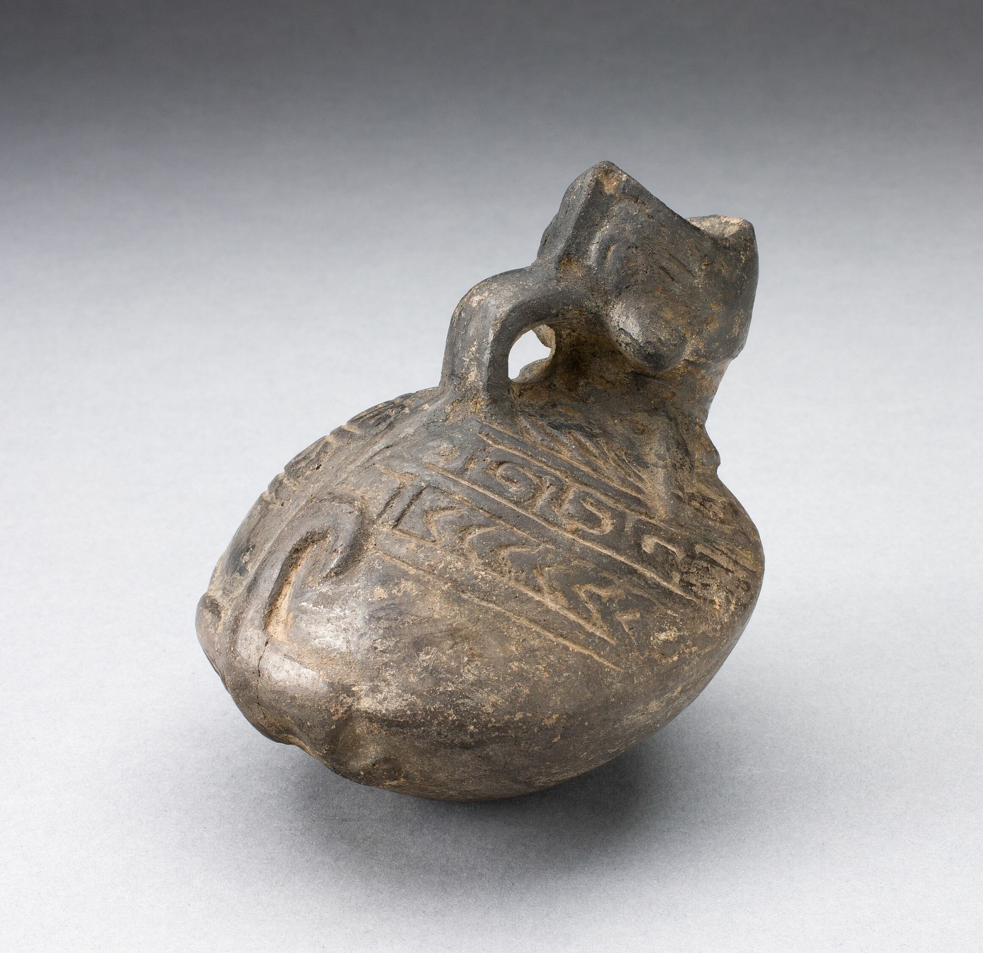 Pitcher in the Form of an Open Mouthed Animal with Geometric Incising on Back by Chimú