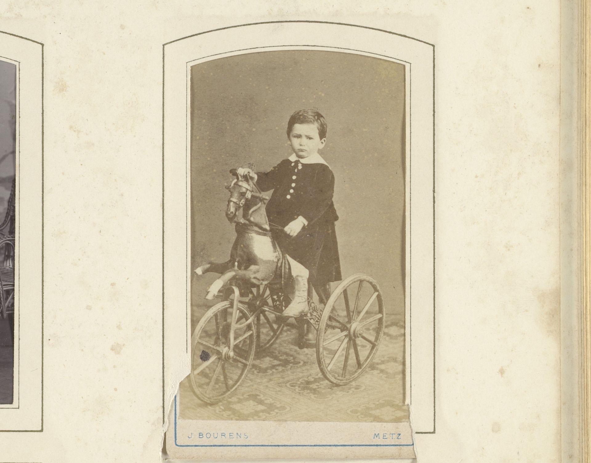 Portret van een jongen op een speelgoed paard met wielen by J. Bourens