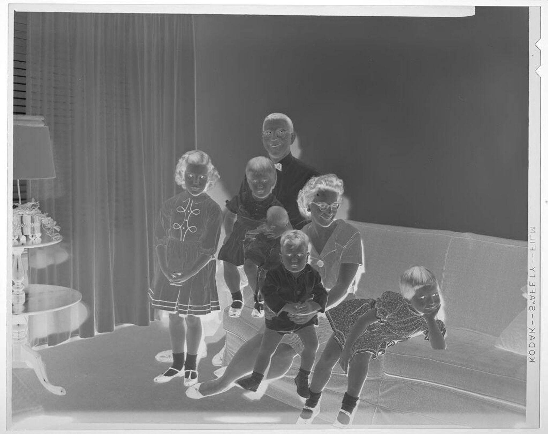 Untitled (family with four young children posed sitting in living room) by Martin Schweig