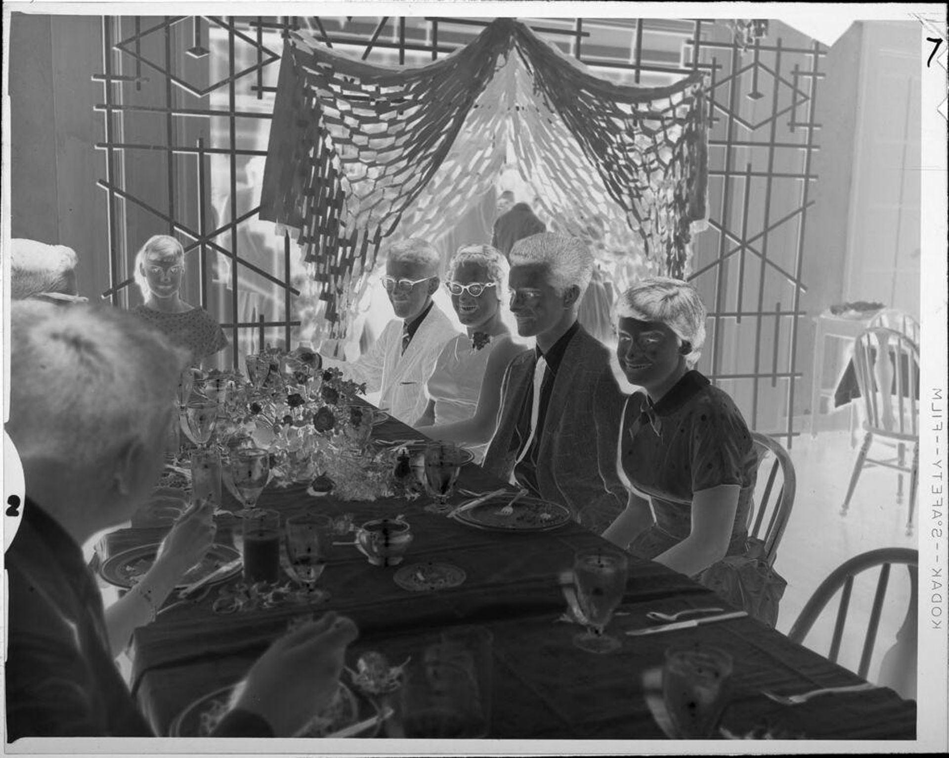 Untitled (people eating at banquet table) by Lucian and Mary Brown