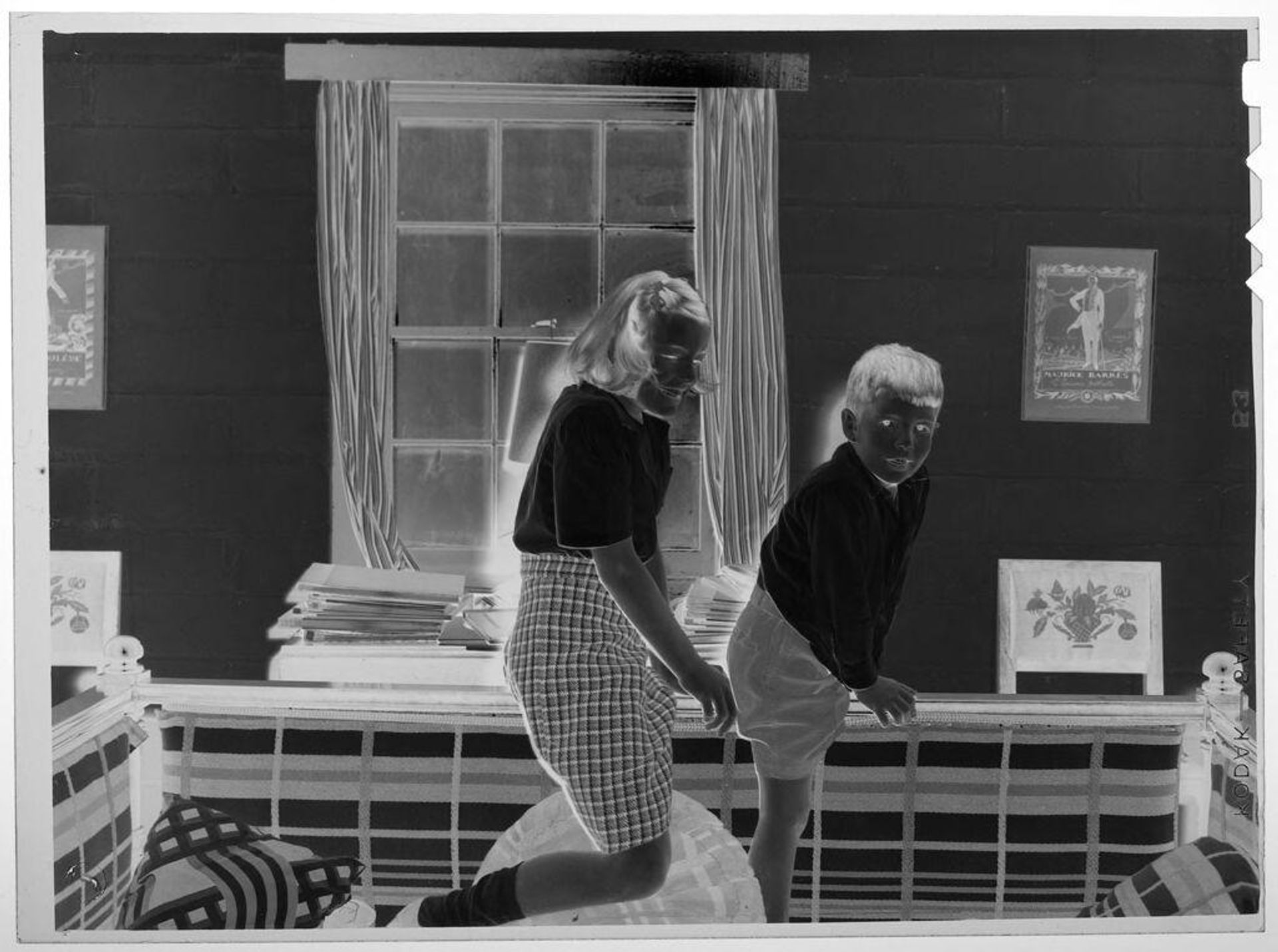 Untitled (girl and boy playing on couch) by Lucian and Mary Brown