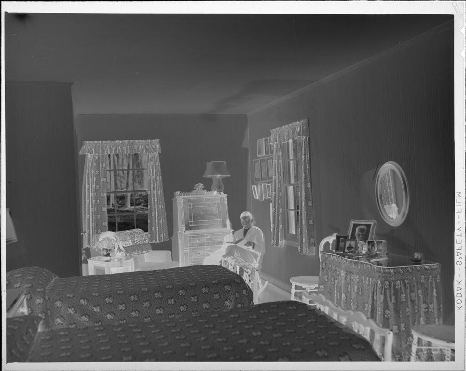 Untitled (boy reading on rocking chair in bedroom) by Lucian and Mary Brown