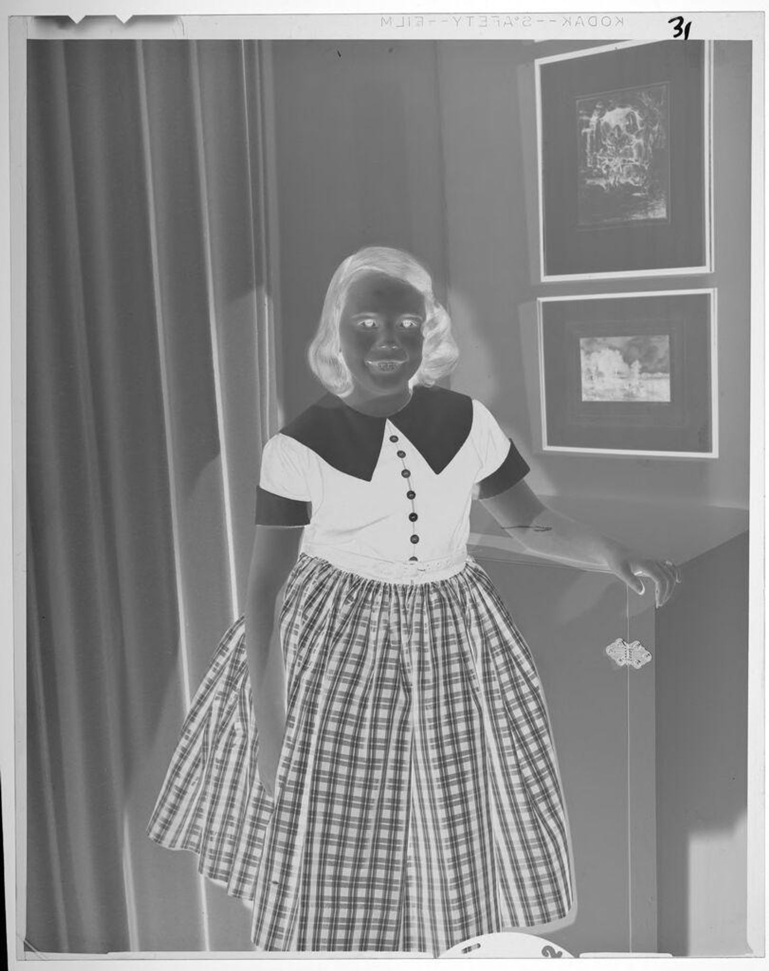 Untitled (portrait of girl in plaid dress) by Lucian and Mary Brown