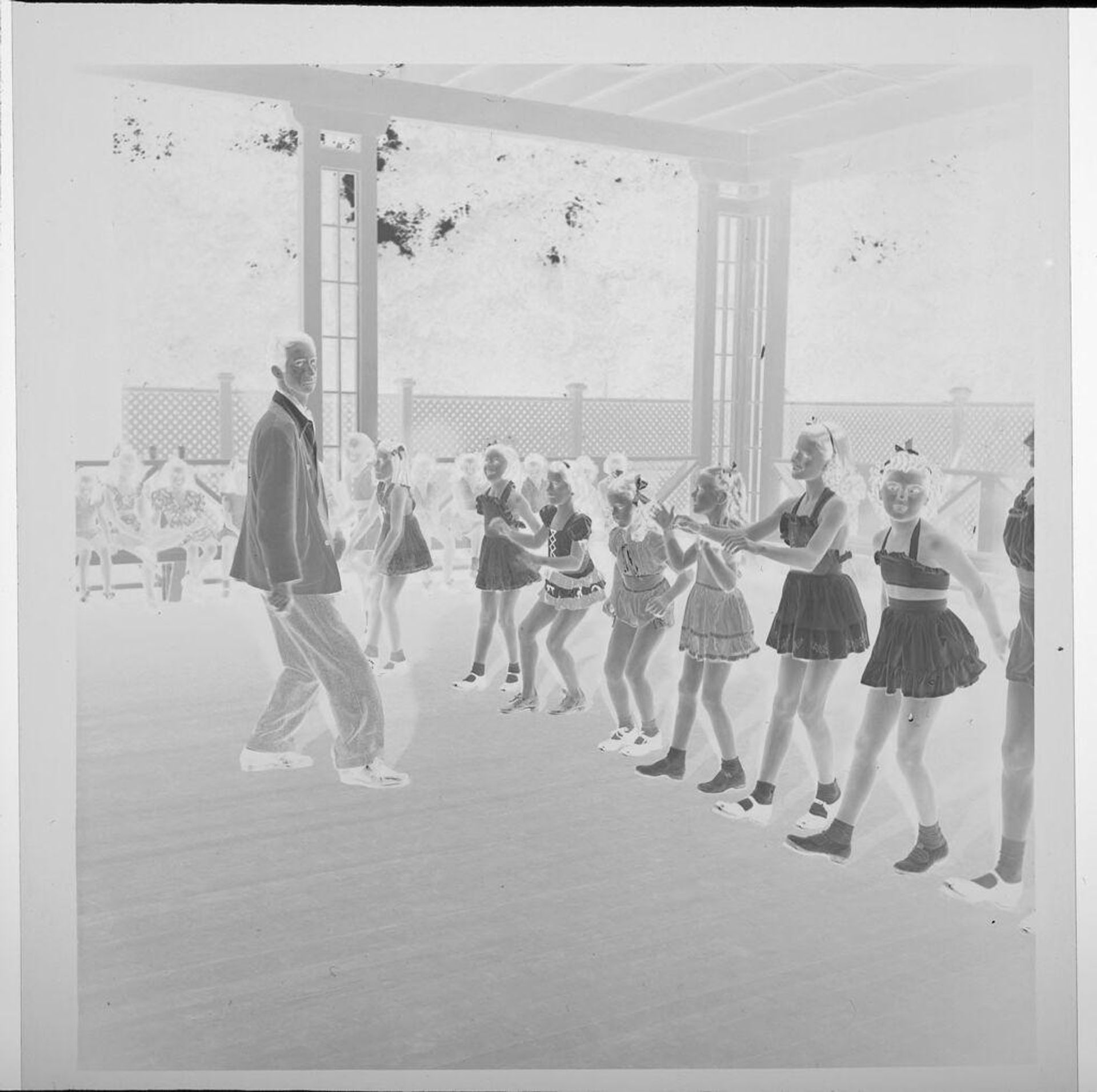 Untitled (man teaching girls a dance) by Jack Gould