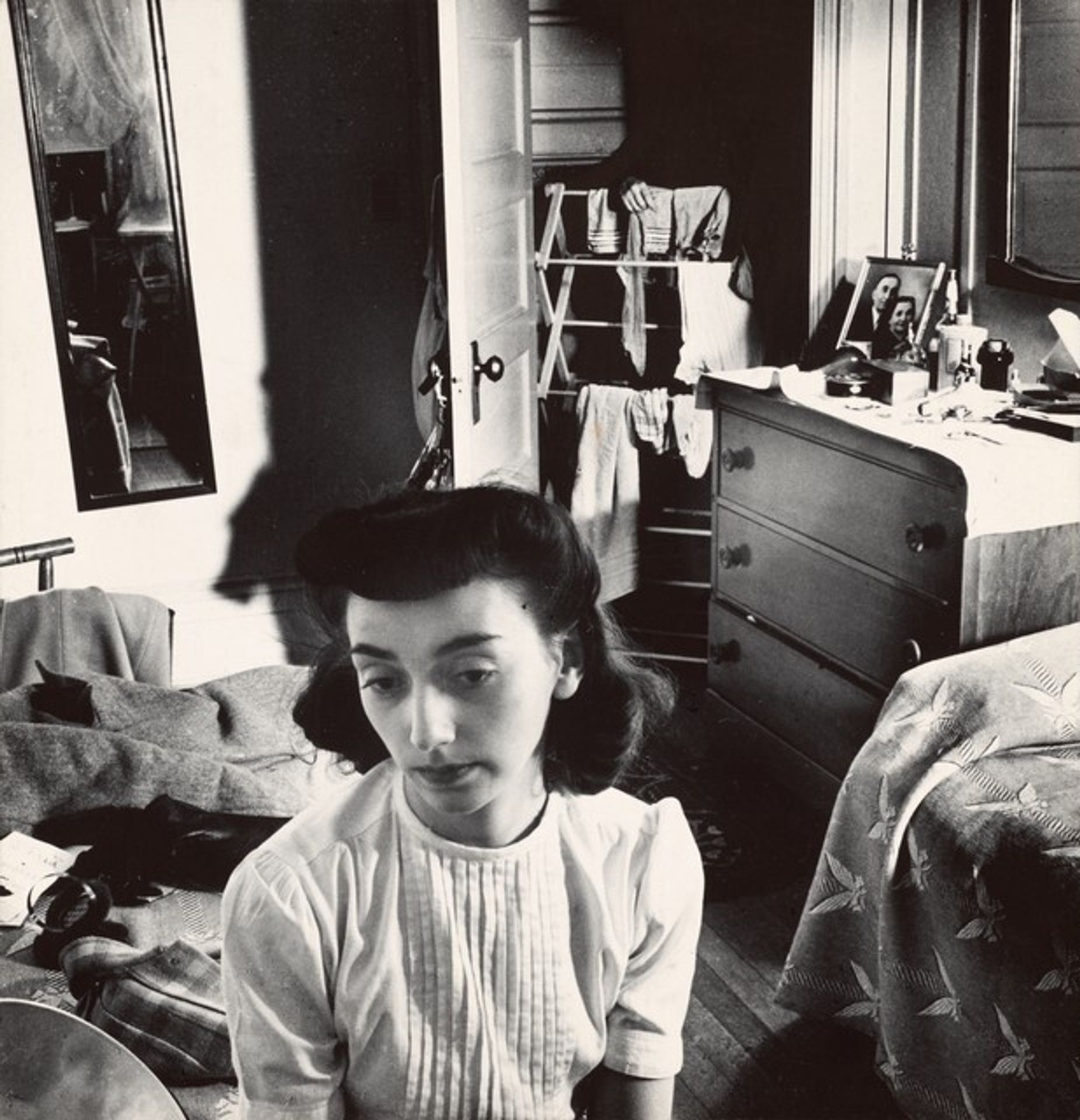Young woman in the doorway of her room at a boardinghouse, Washington, DC by Esther Bubley