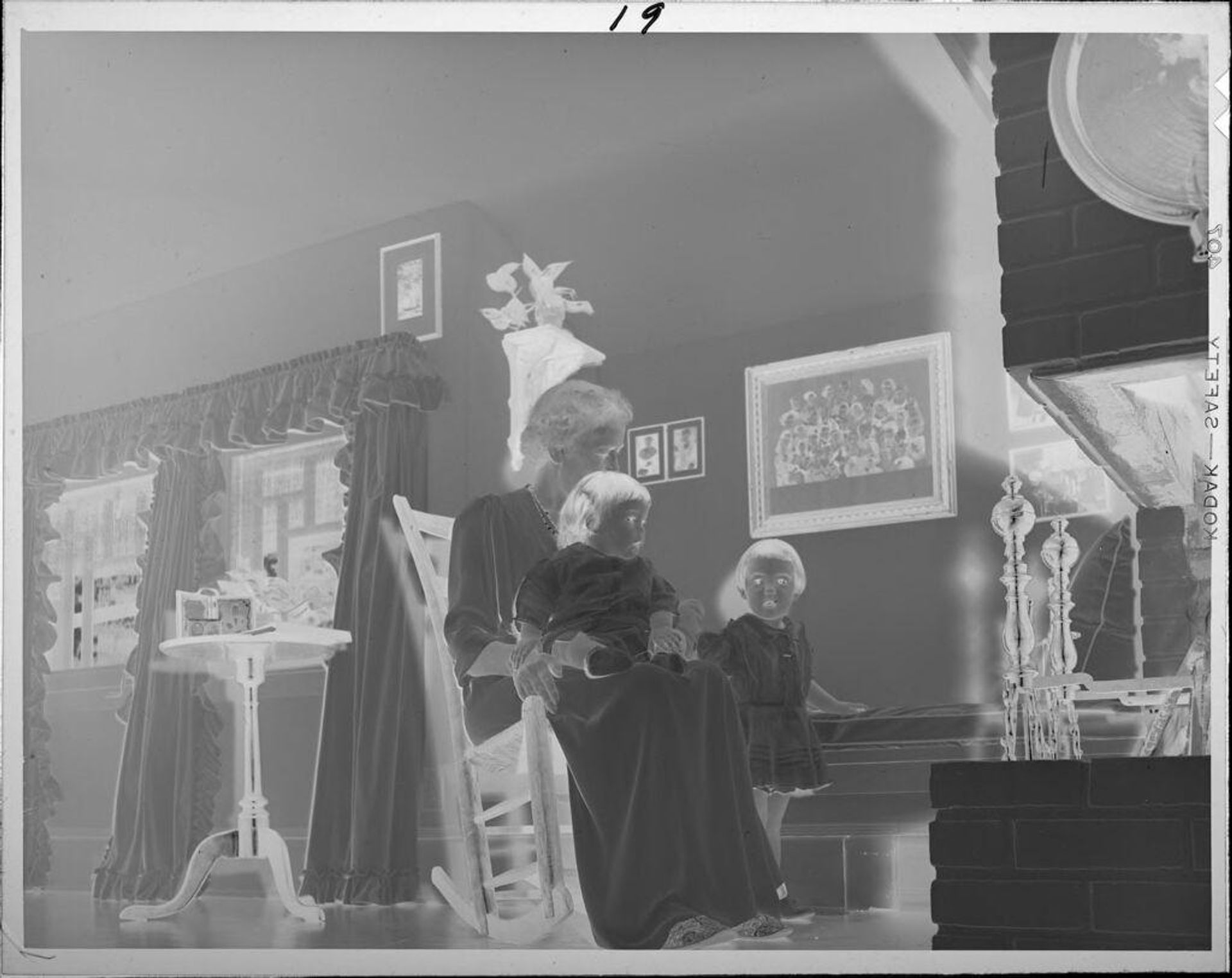 Untitled (woman, possibly, mother or grandmother with two little girls in living room) by Lucian and Mary Brown