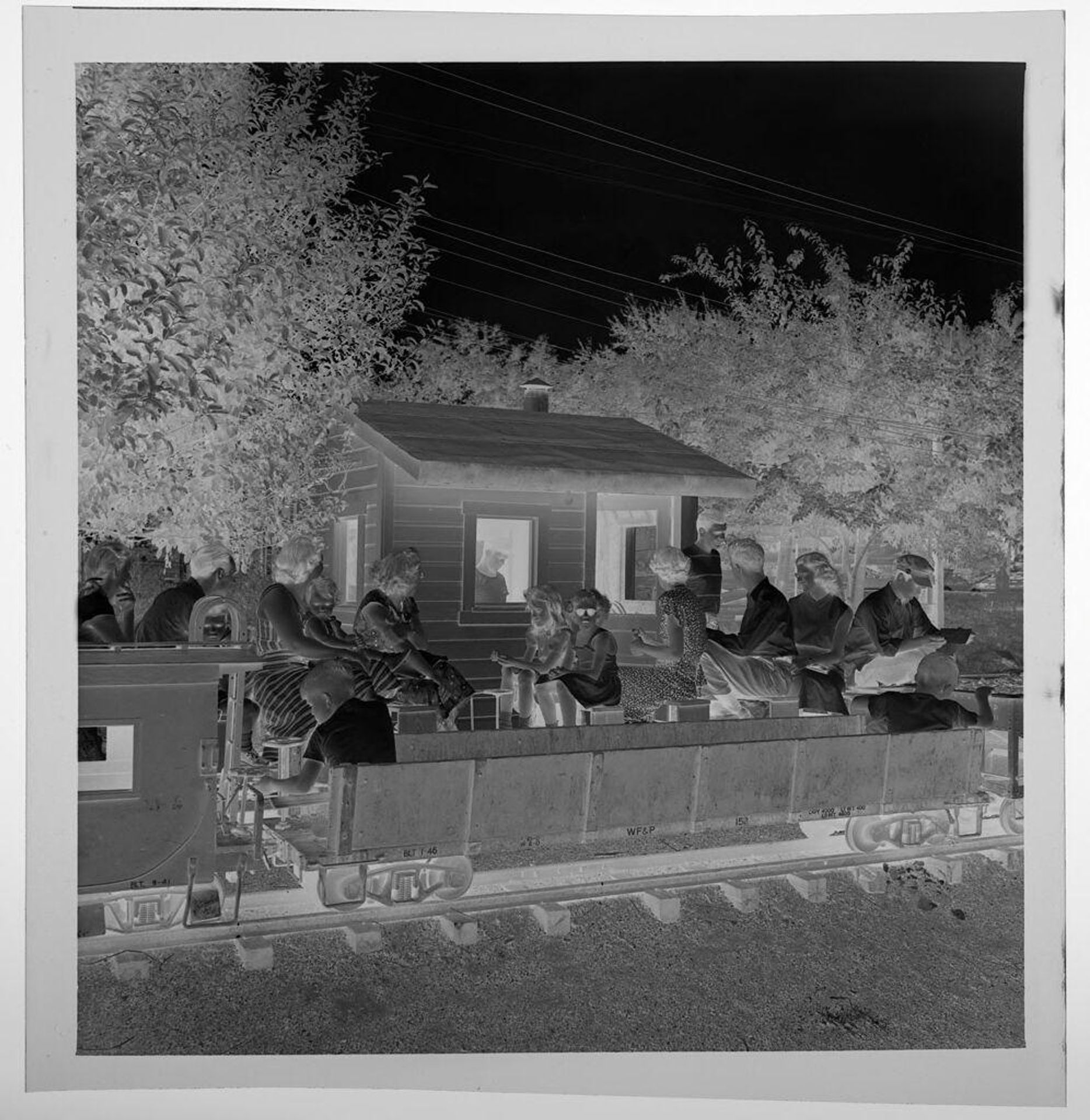 Untitled (mini train on tracks, people in train car) by Jack Gould