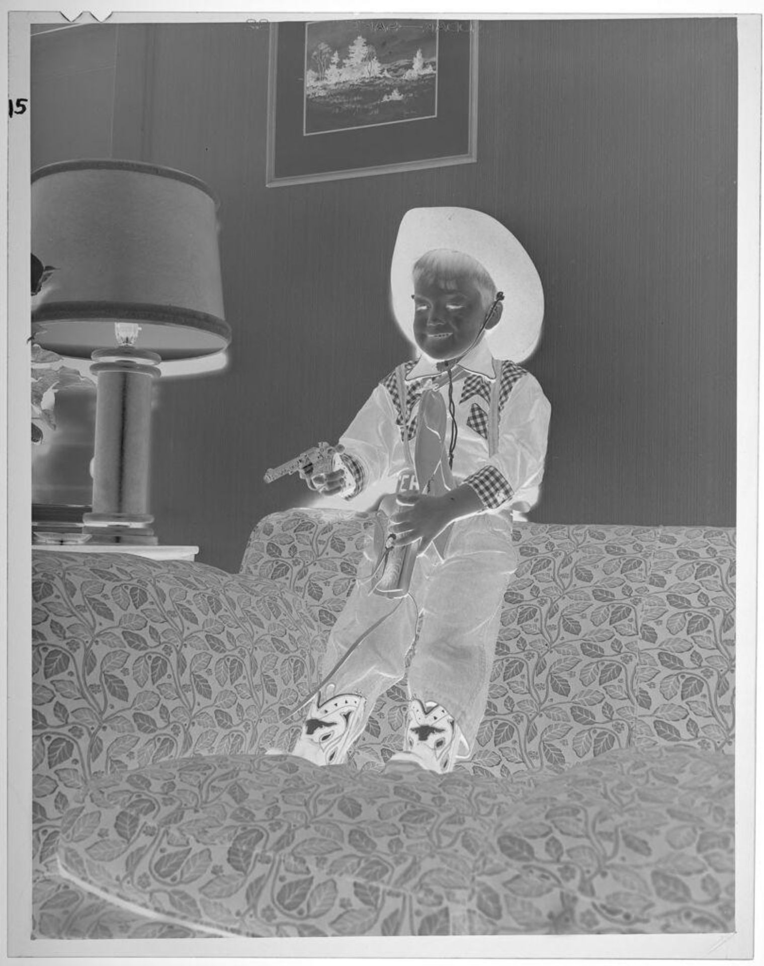 Untitled (boy wearing cowboy costume, with toy gun) by Lucian and Mary Brown