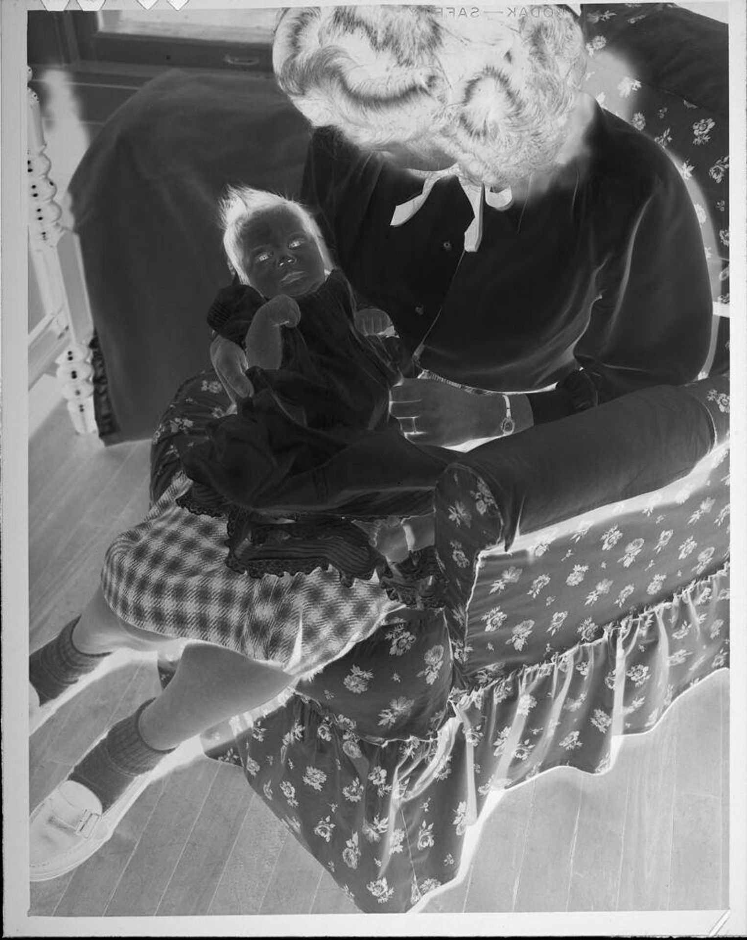 Untitled (woman with infant in lap) by Lucian and Mary Brown