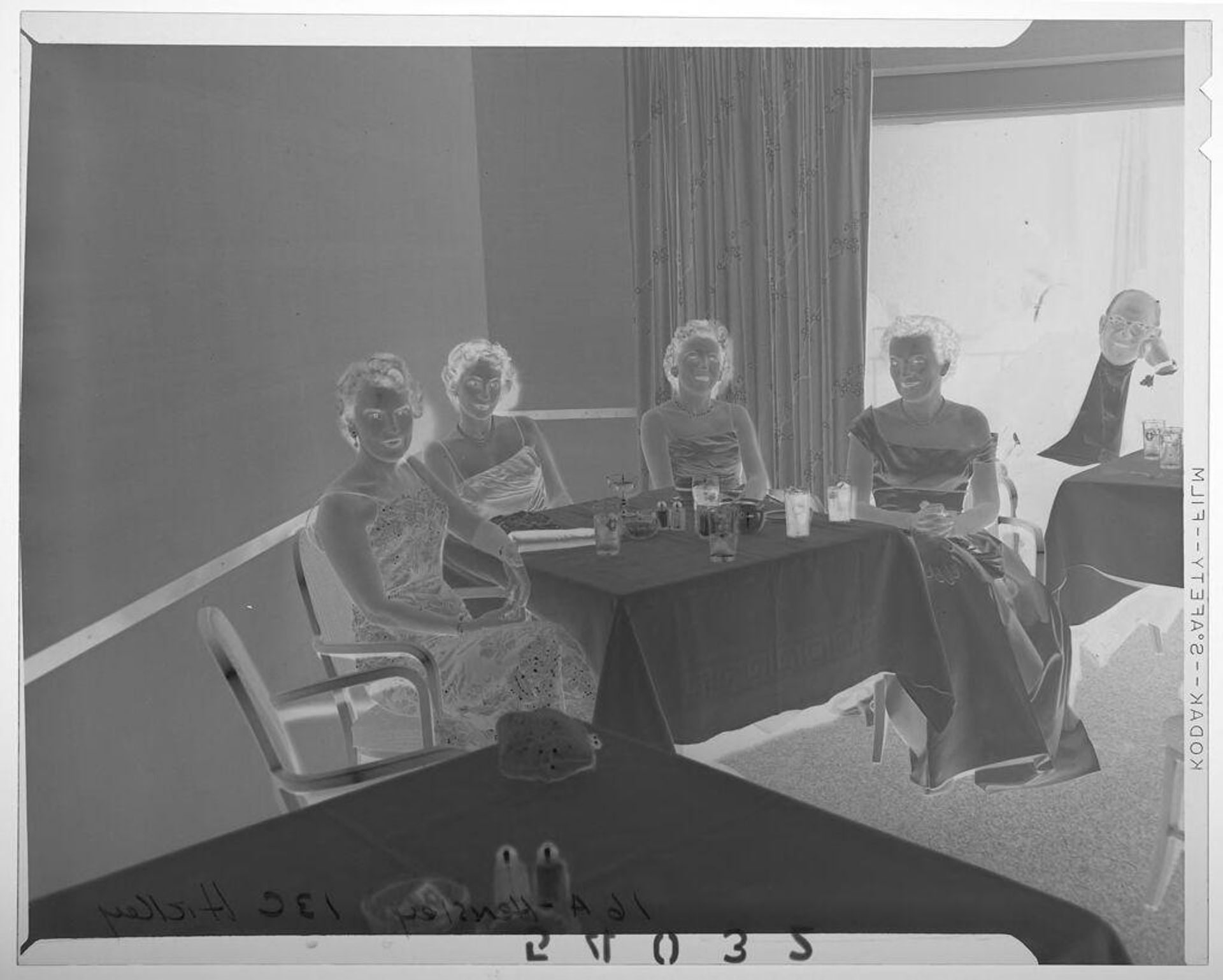Untitled (man and four women sitting at tables at Christmas ball) by Martin Schweig