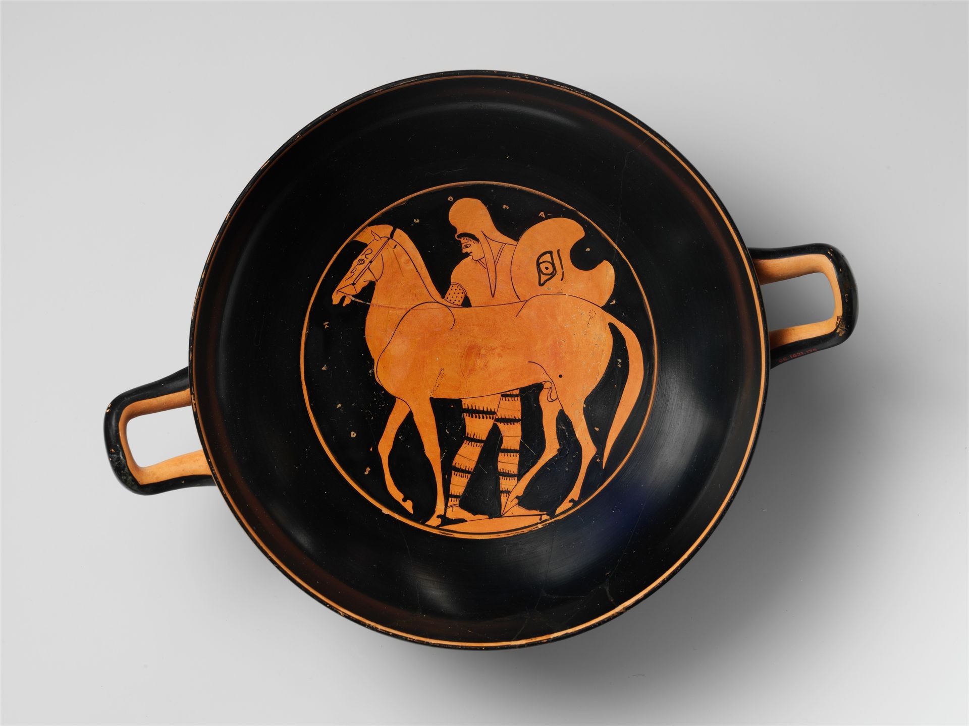Terracotta kylix (drinking cup) with horses by Anonymous