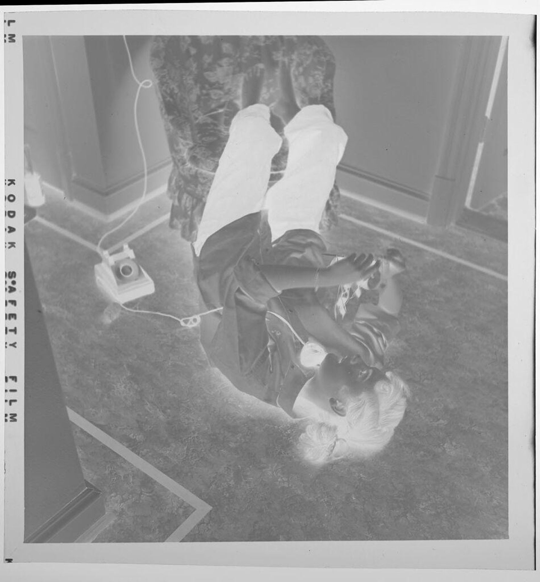 Untitled (girl lying on back talking on telephone) by Jack Gould