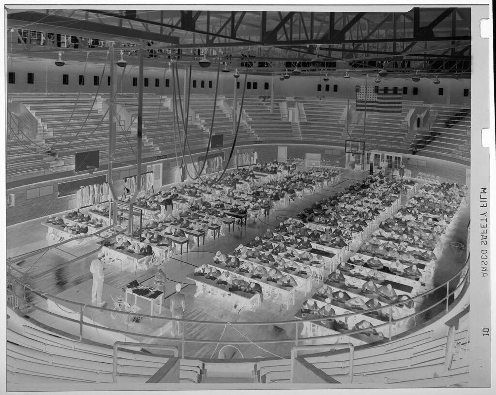 Untitled (many students taking standardized exam inside large gymnasium) by Jack Gould