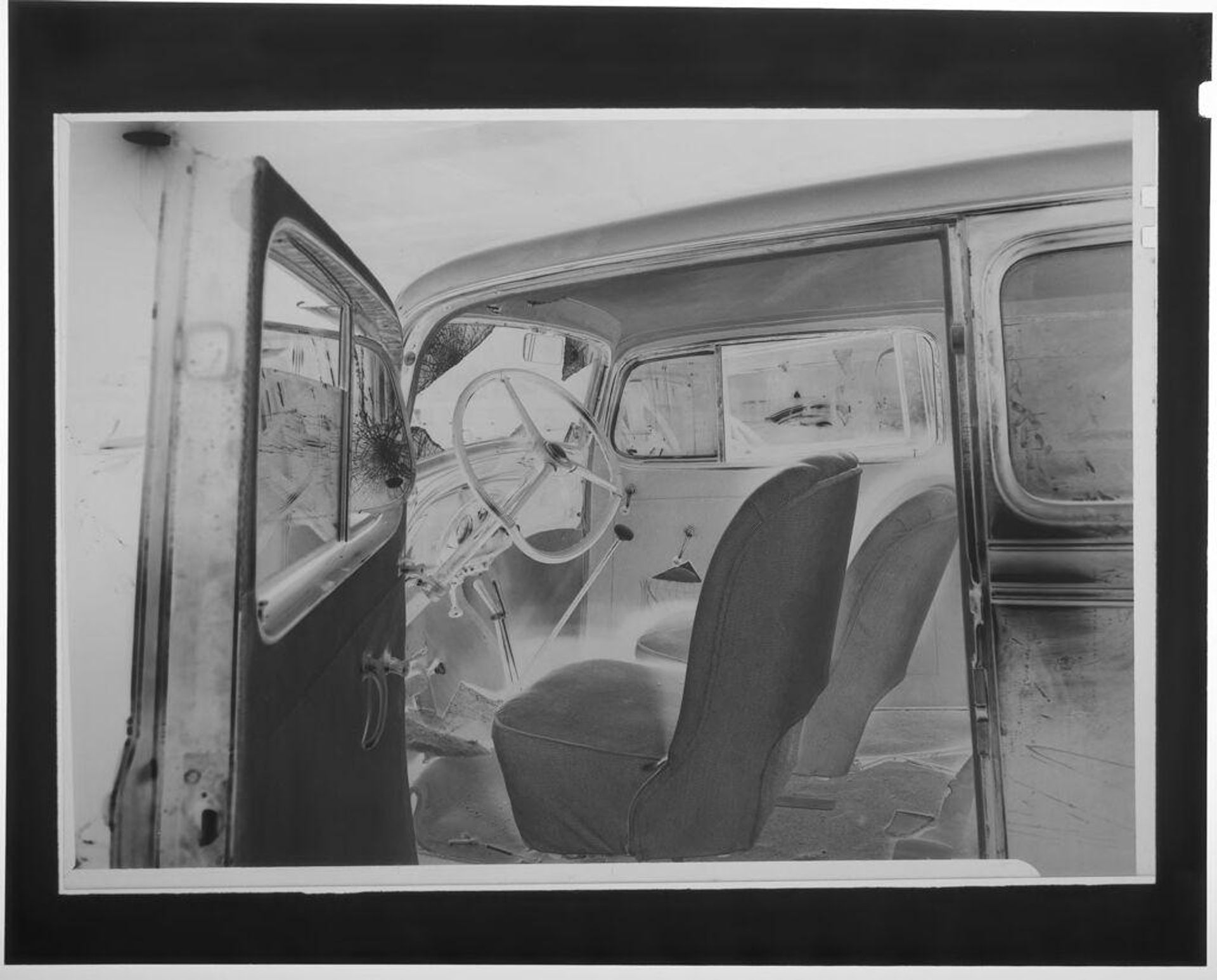 Untitled (interior view of wrecked early model car) by Martin Schweig