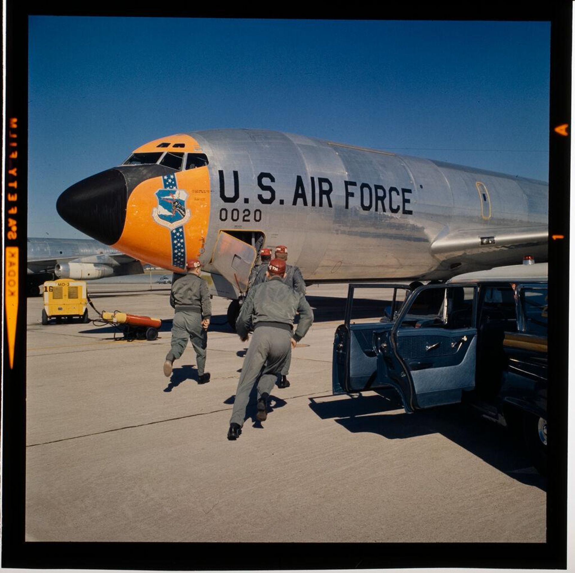 Untitled (men next to large Air Force jet) by Jack Gould